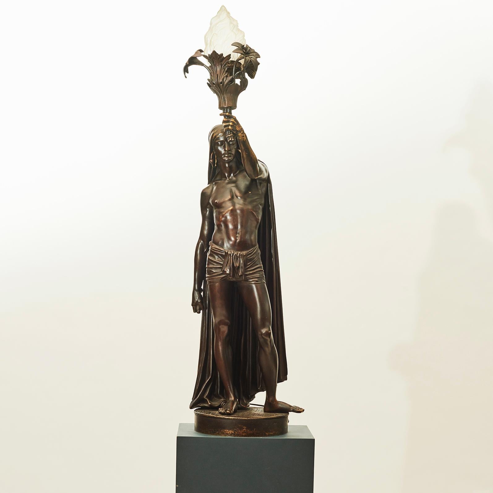 François Christophe Armand Toussaint (1806-1862).
A beautiful patinated bronze figure lamp representing an American Indian, wearing a draped headdress, robe and a pendant hooped earring. Signed to the plinth ‘Graux Marly, Ft. de Bronzes, 8 Rúe Du