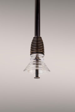 The Insulator 'A' Pendant in dark brass and clear glass by NOVOCASTRIAN deco