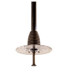 The Insulator 'C' Pendant in dark brass and clear glass by NOVOCASTRIAN