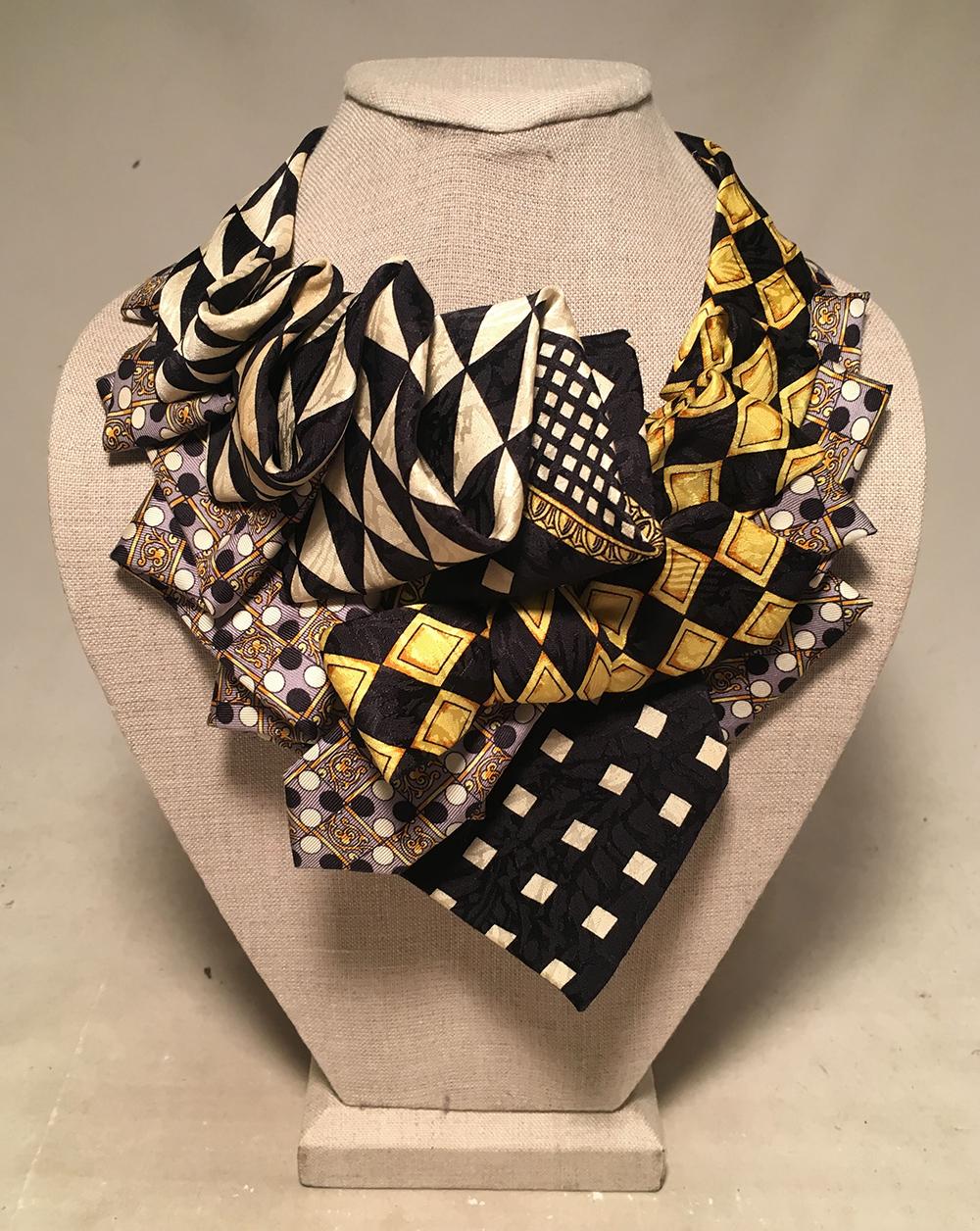 Vintage Versace Black and Yellow silk ties artistically arranged into a gorgeous ascot necklace. Versace black and white print checkered silk tie, Versace black and yellow diamond print vintage tie, and versace checkered checkered print tie with