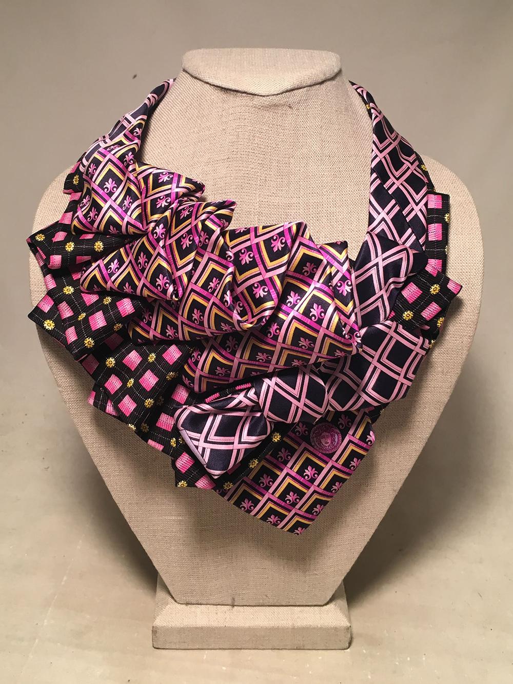 Vintage Versace Silk Ties artistically arranged into a gorgeous ascot necklace. Versace Pink and black square print silk tie with yellow details, Pink yellow and black box print tie, and pink and navy cross hatch print tie all combined and ruched