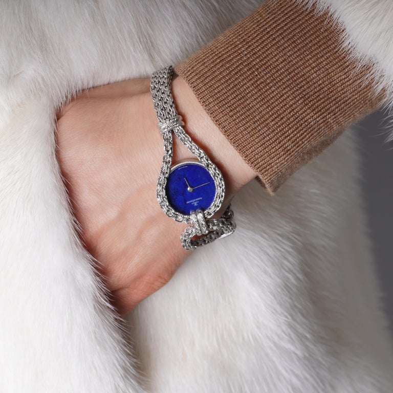 The Jaeger Le - Coultre Lapis Lazuli Dial 18kt white gold ladies' watch is a true masterpiece of craftsmanship and elegance.
The watch features a stunning lapis lazuli dial, encased in a sleek 18kt white gold case. The intricate detailing on the