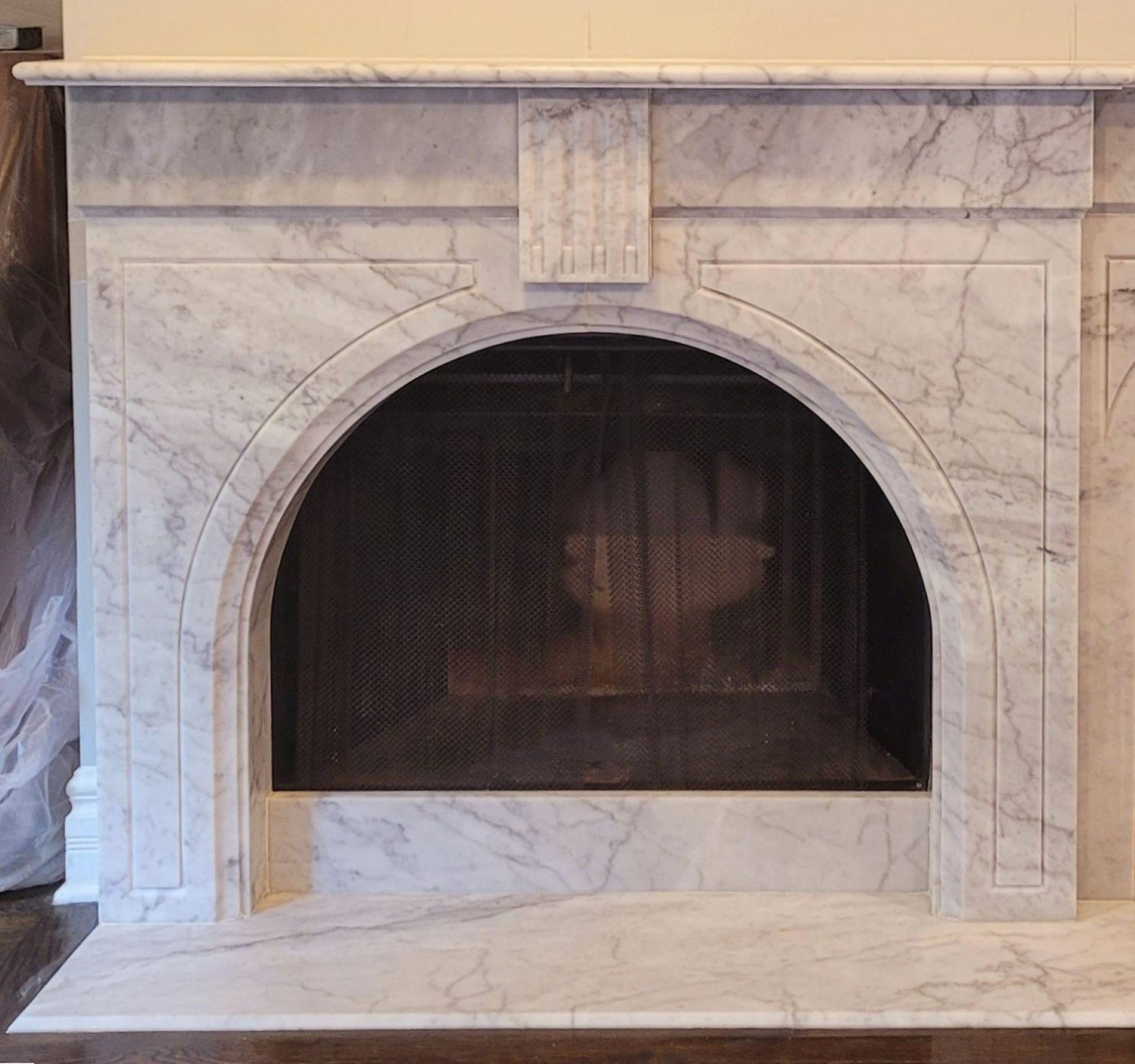 The Josephine stone fireplace, with its wide, fully-arched opening, evokes the 19th century English Victorian era.  Its thin, elegantly-edged shelf piece is followed by a flat section, stepping in to meet triangular panels bordered by an engraved