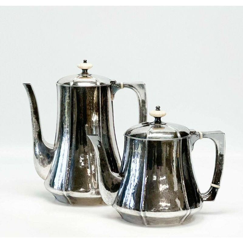 The Kalo Shops Arts & Crafts 4pc silver tea coffee serving set hand hammered

The Kalo Shops Arts and Crafts 4 piece sterling silver tea & coffee serving set, circa 1915. Hand hammered decoration to the body, natural carved joints to tea and