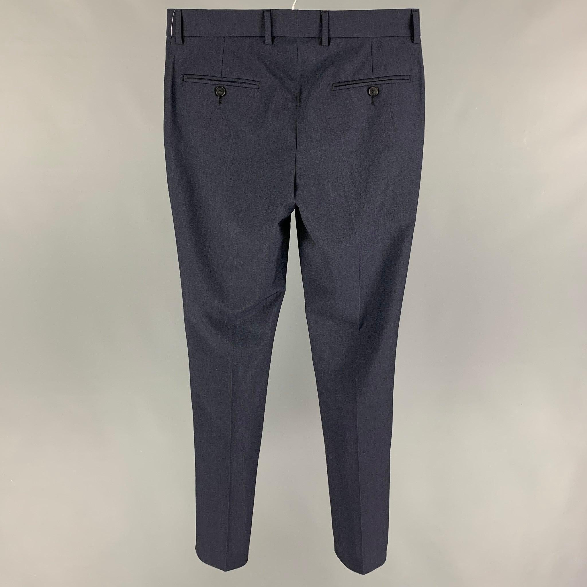 THE KOOPLES dress pants comes in a navy wool / mohair featuring a slim fit, front tab, and a zip fly closure.
Very Good
Pre-Owned Condition. 

Marked:   44 

Measurements: 
  Waist: 30 inches  Rise: 9 inches  Inseam: 32 inches 
  
  
 
Reference: