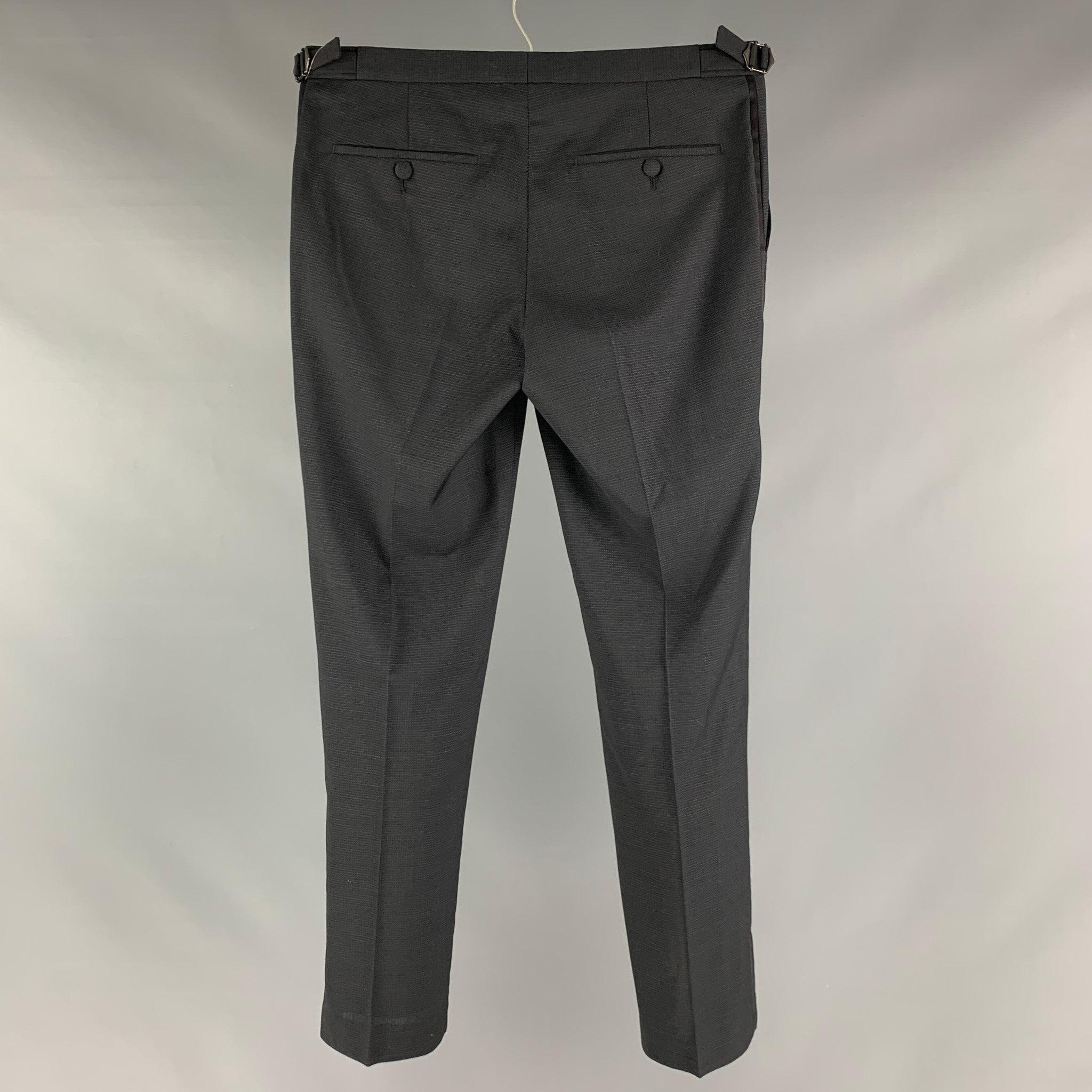 THE KOOPLES dress pants comes in a black wool woven material featuring a regular fit, side tabs, and zipper fly closure. Excellent Pre-Owned Condition. 

Marked:  46 

Measurements: 
 Waist: 30 inches Rise: 7.5 inches Inseam: 29 inches 
 
 
