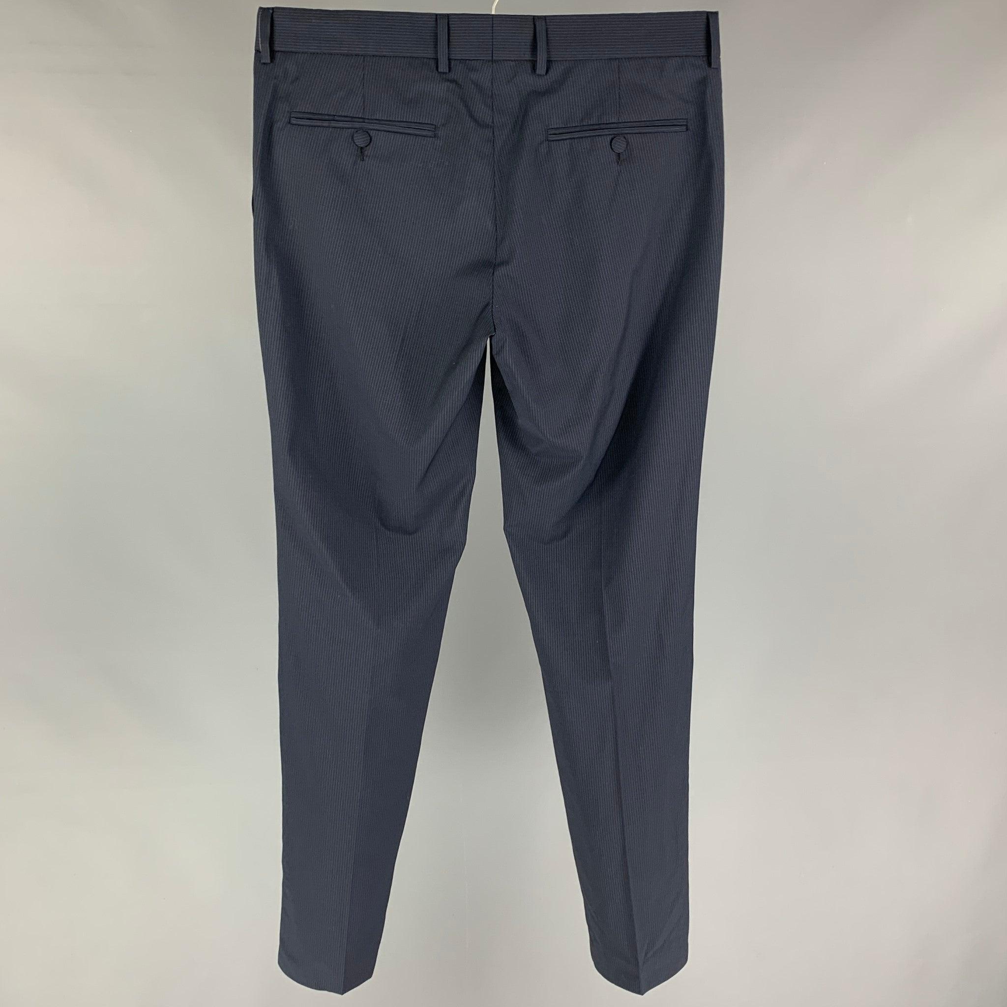 THE KOOPLES dress pants comes in a navy stripe wool featuring a slim fit, front tab, and a zip fly closure.
New with tags.  

Marked:   48 

Measurements: 
  Waist: 34 inches Rise: 9 inches Inseam: 32 inches Leg Opening: 14 inches 

  
  
