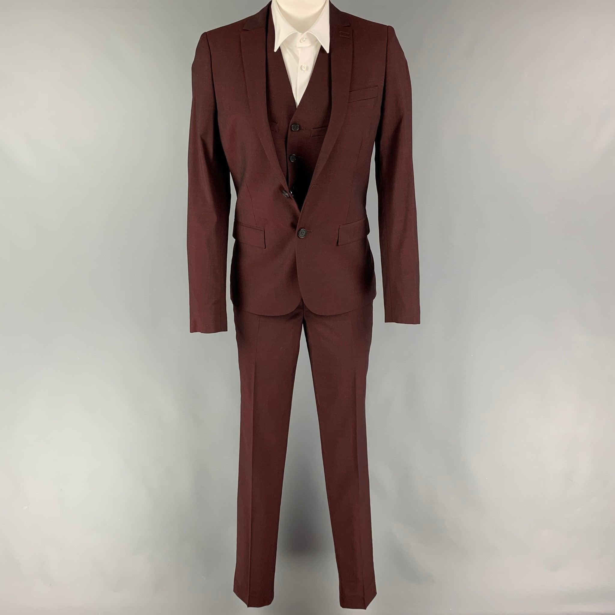 THE KOOPLES 3 Piece
suit comes in a burgundy wool with a full liner and includes a single breasted, double button sport coat with a notch lapel and a matching vest & flat front trousers. New With Tags.  

Marked:   44 

Measurements: 
 