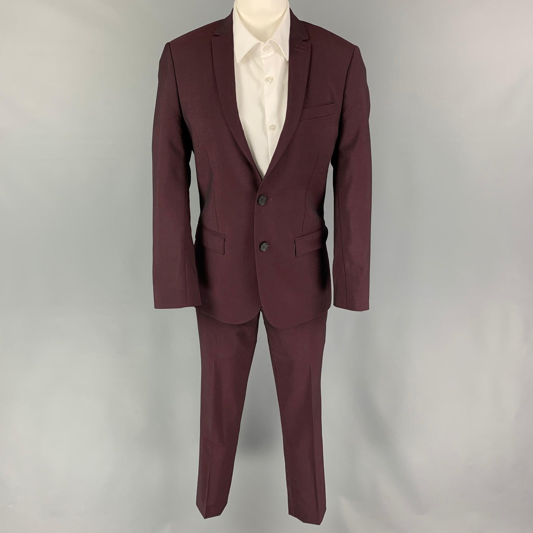 THE KOOPLES
suit comes in a burgundy wool / mohair with a full liner and includes a single breasted, double button sport coat with a notch lapel and matching flat front trousers. Excellent Pre-Owned Condition. 

Marked:   44 

Measurements: 
 