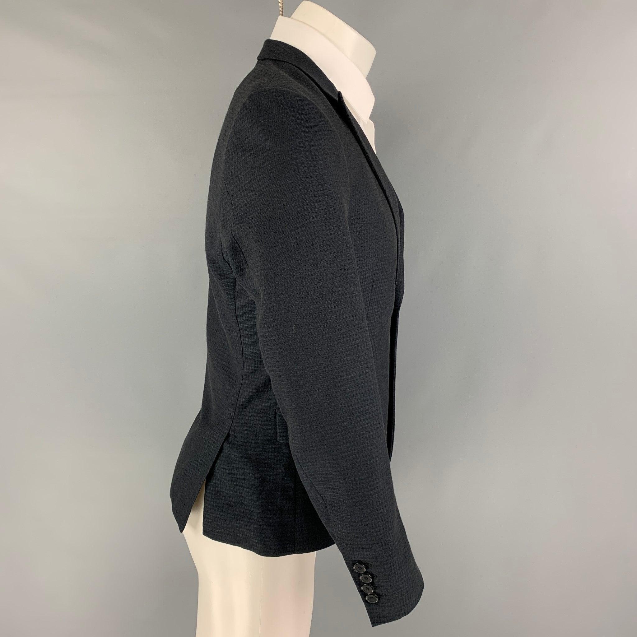 THE KOOPLES sport coat comes in a black grid wool with a full liner featuring a peak lapel, flap pockets, double back vent, and a double button closure.
Excellent
Pre-Owned Condition. 

Marked:   46 

Measurements: 
 
Shoulder: 16.5 inches Chest: 36