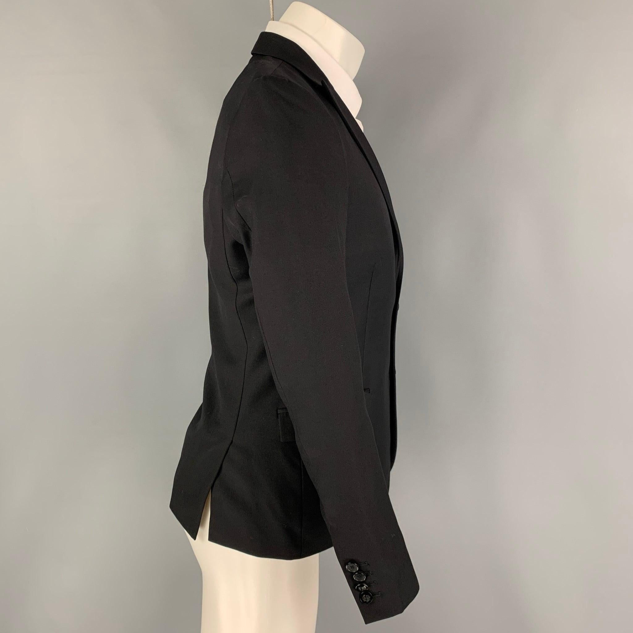 THE KOOPLES sport coat comes in a black wool with a full liner featuring a peak lapel, flap pockets, double back vent,and a double button closure.
Excellent
Pre-Owned Condition. 

Marked:   46 

Measurements: 
 
Shoulder: 16 inches Chest: 36 inches