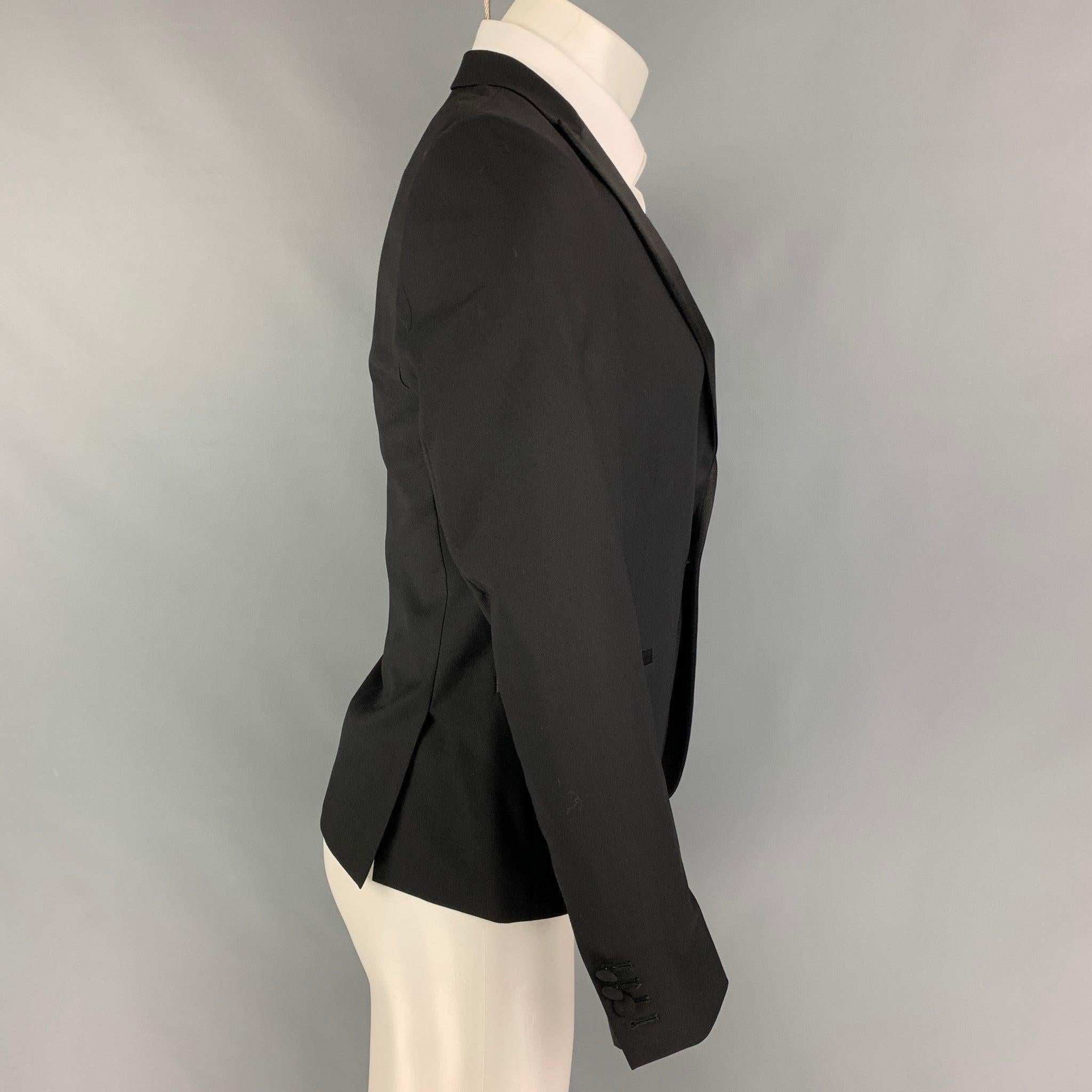 THE KOOPLES sport coat comes in a black wool with a full liner featuring a peak lapel, slit pockets, double back vent, and a single button closure.
Very Good
Pre-Owned Condition. 

Marked:   46 

Measurements: 
 
Shoulder: 16.5 inches  Chest: 38