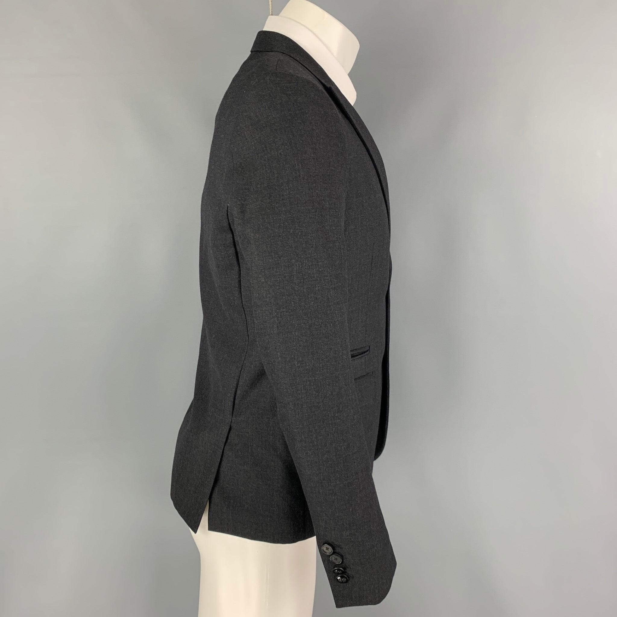 THE KOOPLES sport coat comes in a charcoal wool with a full liner featuring a peak lapel, flap pockets, double back vent, and a double button closure.
Excellent
Pre-Owned Condition. 

Marked:   46 

Measurements: 
 
Shoulder: 16 inches Chest: 36