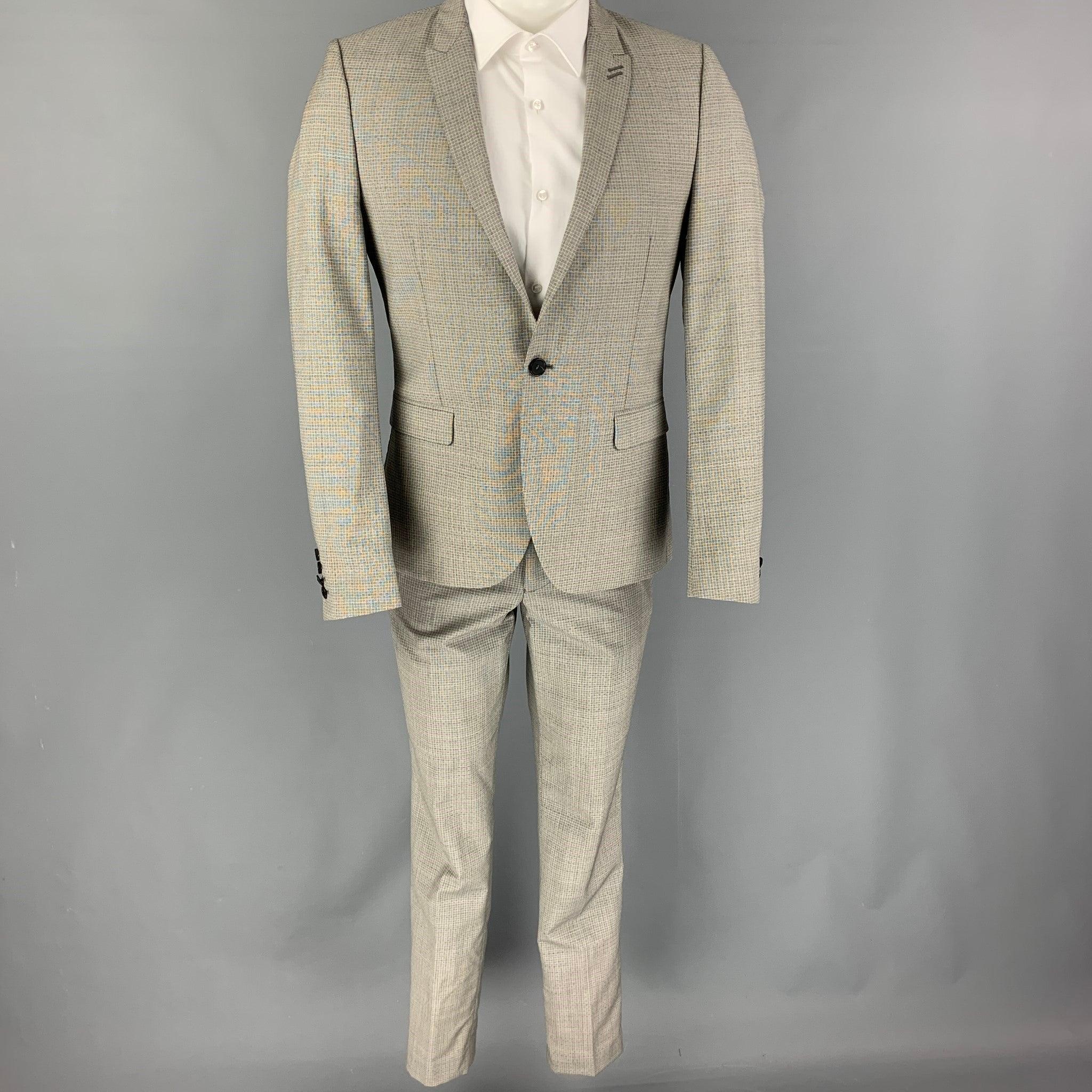 THE KOOPLES
suit comes in a grey & black wool / mohair with a full liner and includes a single breasted, single button sport coat with a peak lapel and matching flat front trousers. Good Pre-Owned Condition.
Light discoloration & wear throughout.