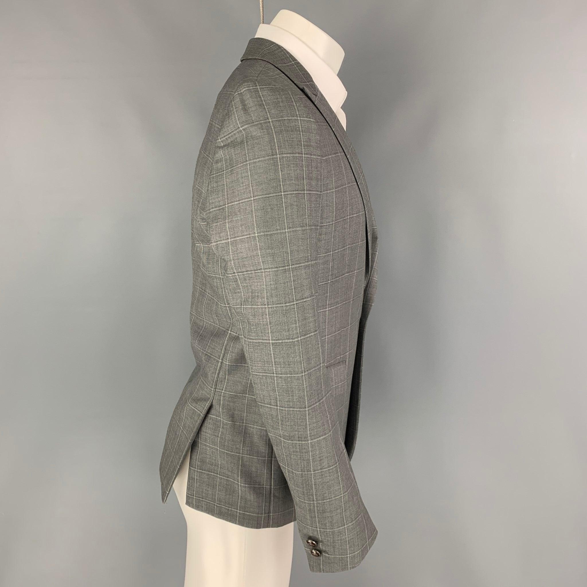 THE KOOPLES sport coat comes in a grey window pane with a full liner featuring a peak lapel, flap pockets, double back vent, and a single button closure.
Excellent
Pre-Owned Condition. 

Marked:   46 

Measurements: 
 
Shoulder: 17 inches Chest: 36