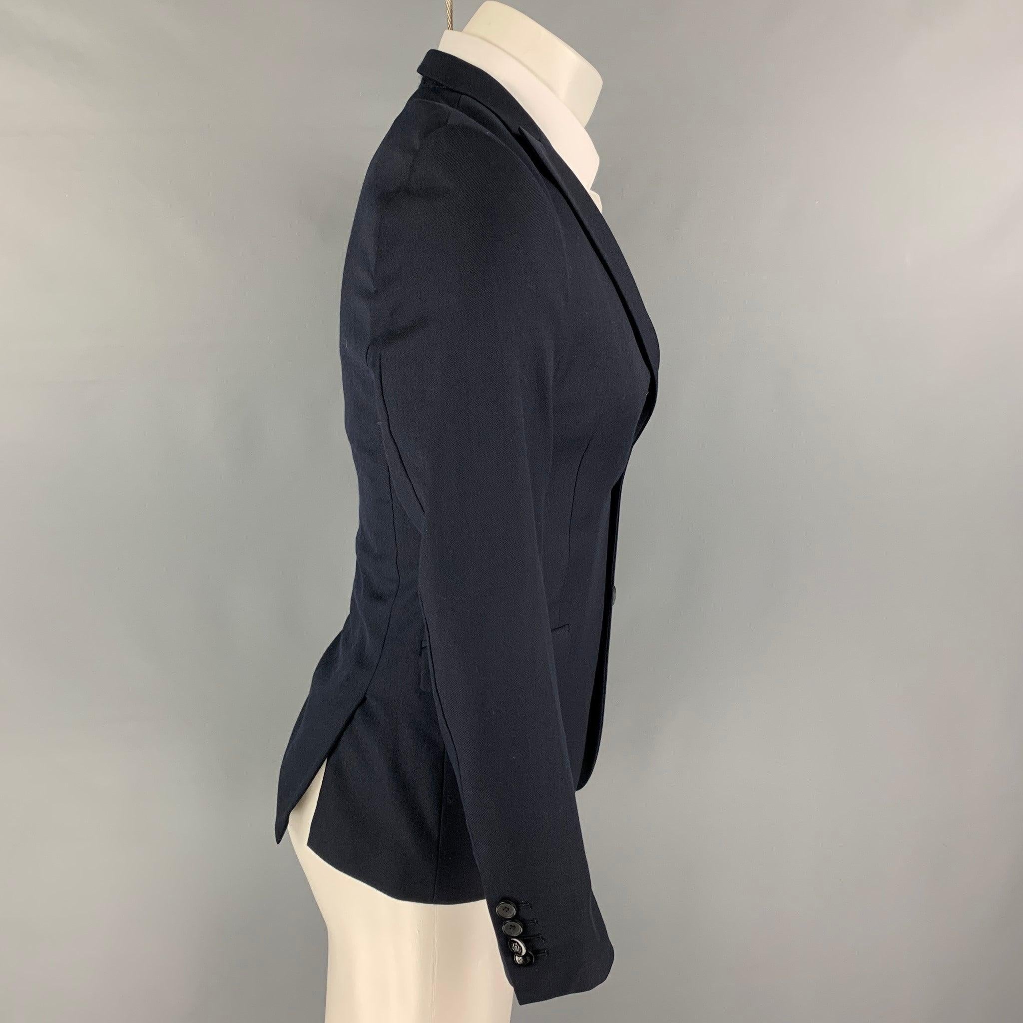 THE KOOPLES sport coat comes in a navy wool with a full liner featuring a peal lapel, flap pockets, double back vent, and a double button closure. Excellent
Pre-Owned Condition. 

Marked:   46 

Measurements: 
 
Shoulder: 16.5 inches Chest: 36