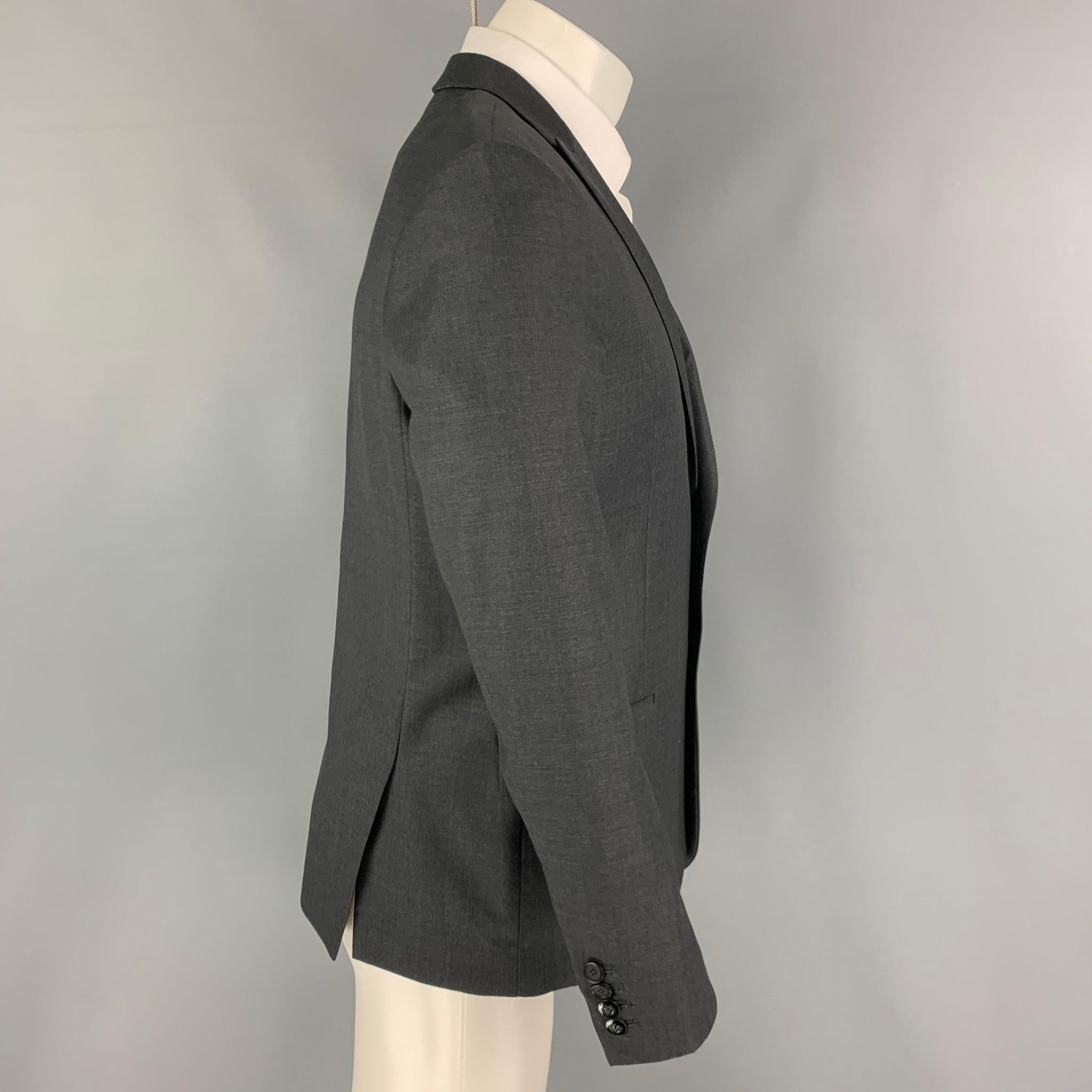 THE KOOPLES sport coat comes in a charcoal wool with a full liner featuring a peak lapel, flap pockets, double back vent, and a double button closure.
Excellent
Pre-Owned Condition. 

Marked:   48 

Measurements: 
 
Shoulder: 18 inches Chest:
38