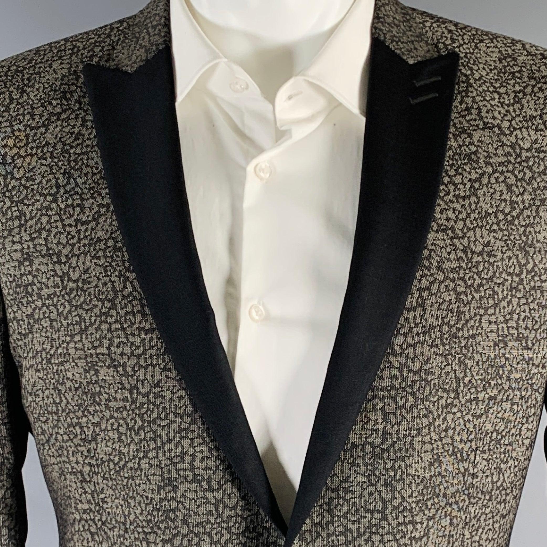 THE KOOPLES sport coat
in a grey and black cotton stretch blend fabric featuring a peak lapel, double vented back, and single button closure. Made in Croatia.Excellent Pre-Owned Condition. 

Marked:   48 

Measurements: 
 
Shoulder: 17 inches Chest: