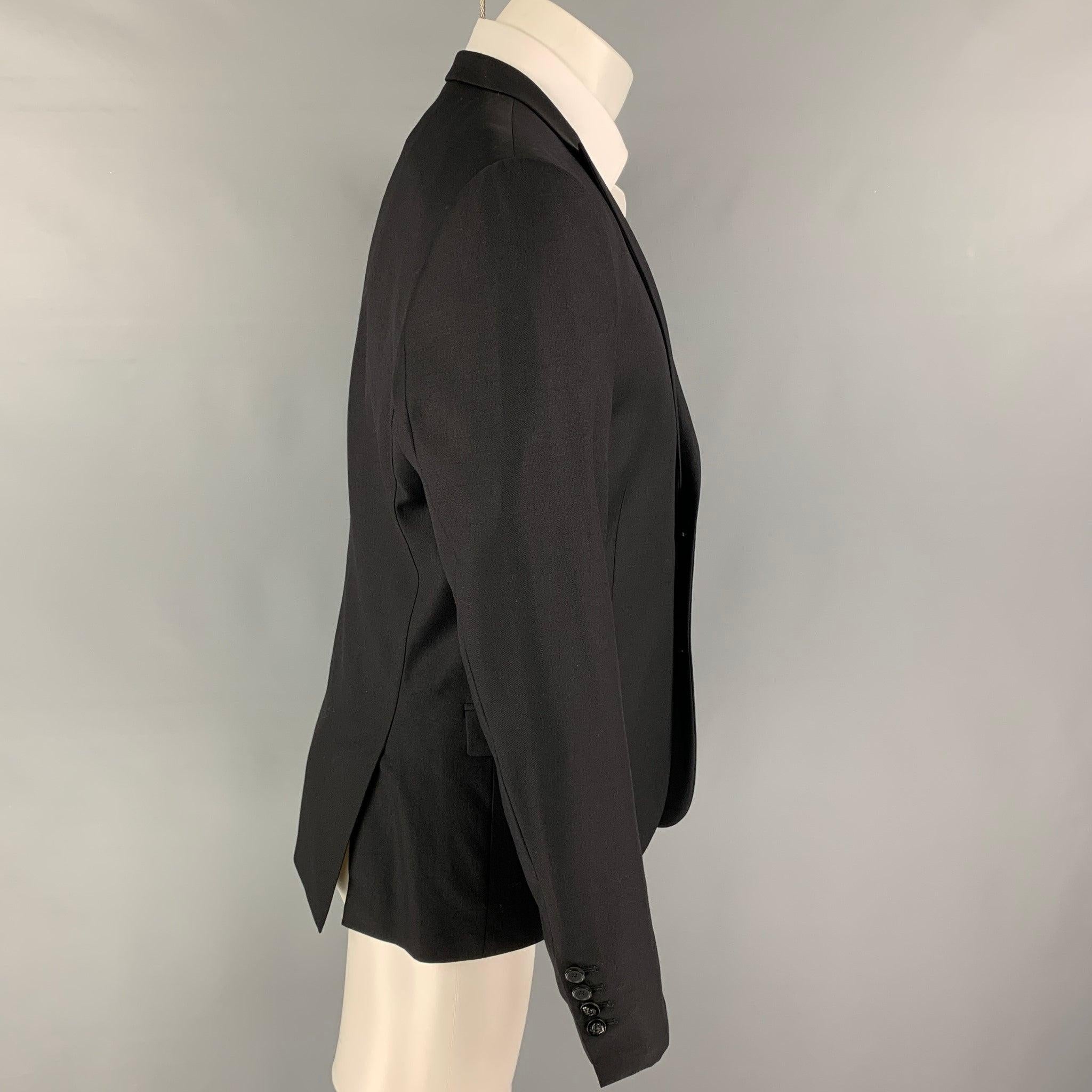 THE KOOPLES
sport coat comes in a black wool with a full liner featuring a peak lapel, flap pockets, double back vent, and a double button closure. Excellent
Pre-Owned Condition. 

Marked:   50 

Measurements: 
 
Shoulder: 17.5 inches Chest: 40