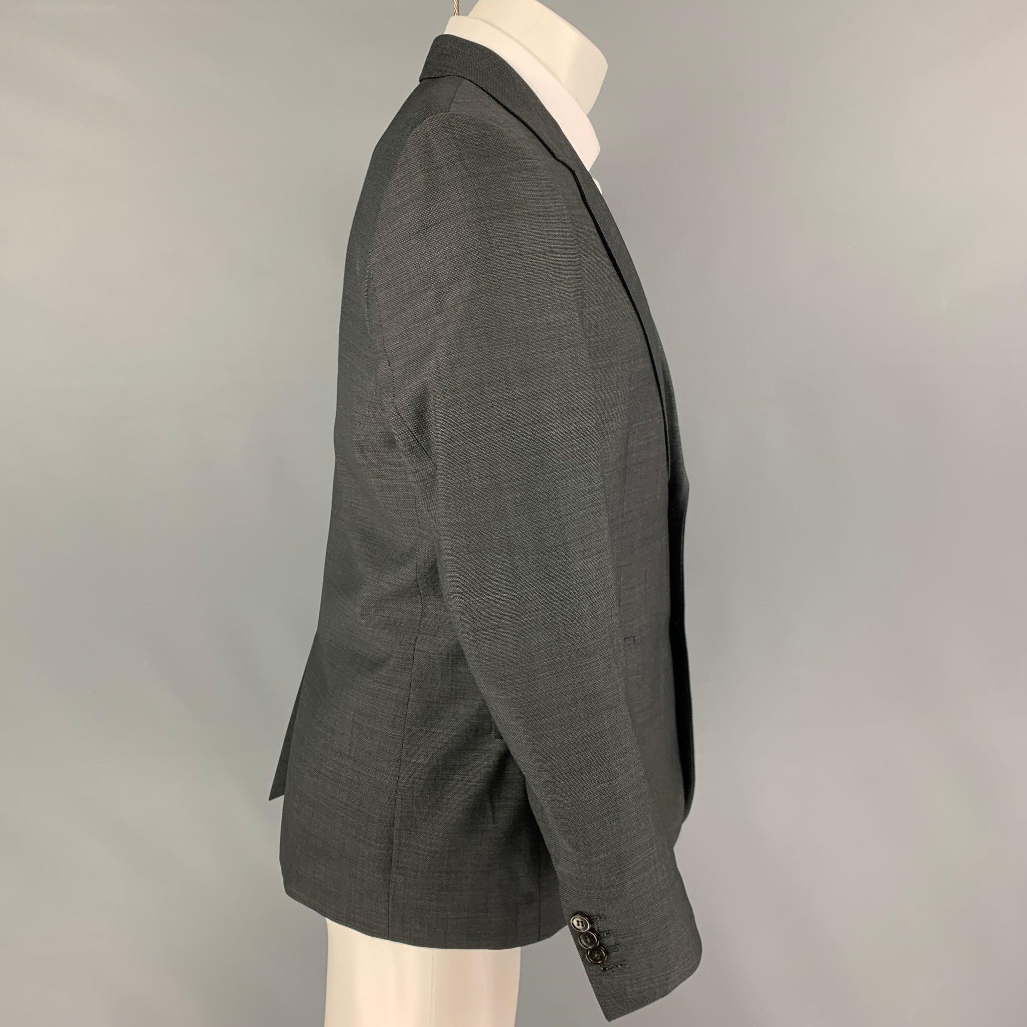 THE KOOPLES
sport coat comes in a charcoal wool with a full liner featuring a notch lapel, flap pockets, single back vent, and a double button closure.Very Good Pre-Owned Condition.  

Marked:   50 

Measurements: 
 
Shoulder: 18 inches  Chest: 40