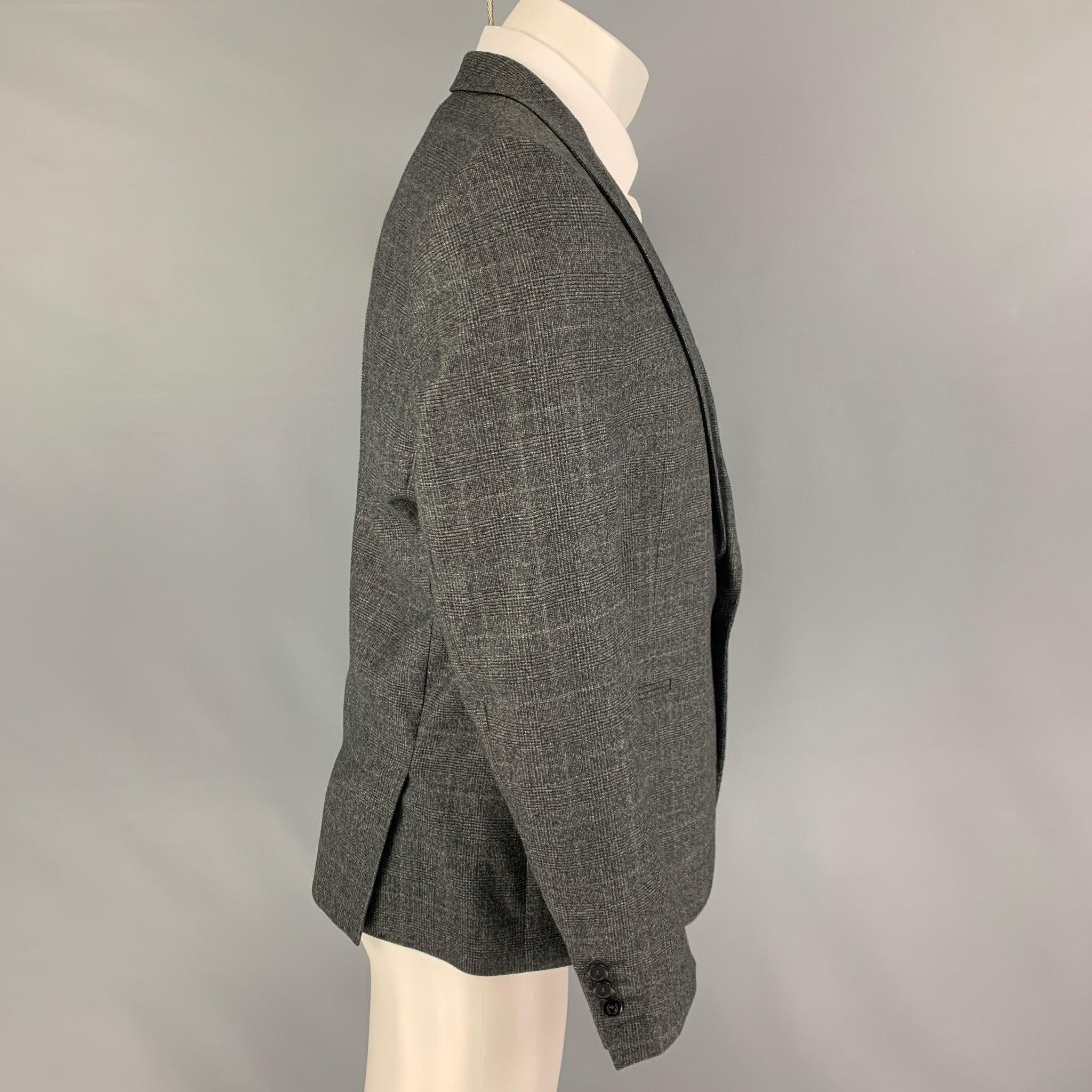 THE KOOPLES
sport coat comes in a dark gray glenplaid wool with a full liner featuring a peak lapel, slit pockets, double back vent, and a single button closure.Very Good Pre-Owned Condition. Small seam rip. As-is.  

Marked:   50 

Measurements: 
