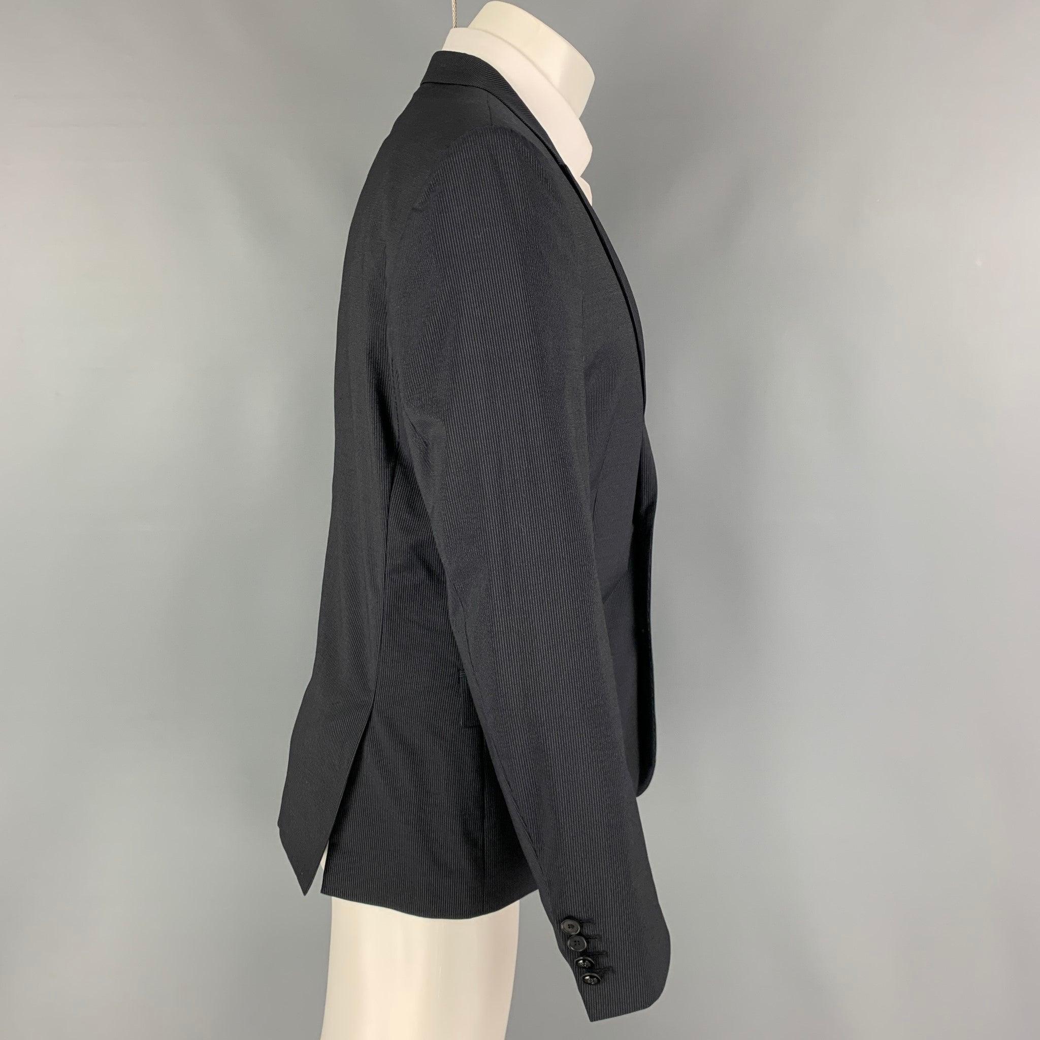 THE KOOPLES sport coat comes in a navy pinstripe wool with a full liner featuring a peak lapel, flap pockets, double back vent, and a double button closure.
Excellent
Pre-Owned Condition. 

Marked:   50 

Measurements: 
 
Shoulder: 18 inches Chest: