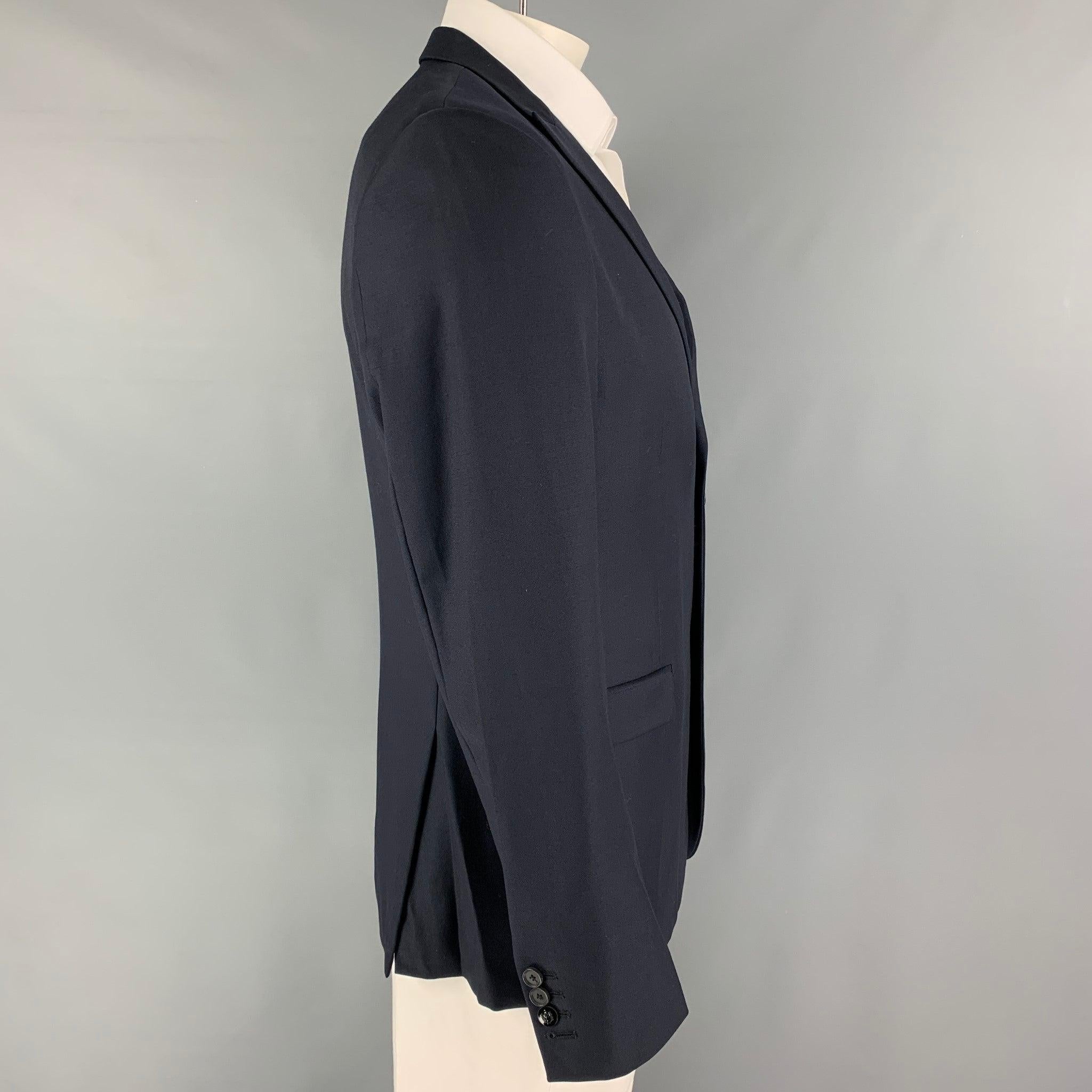 THE KOOPLES sport coat comes in a navy wool with a full liner featuring a peak lapel, flap pockets, double back vent, and a double button closure. Excellent
Pre-Owned Condition. 

Marked:   52 

Measurements: 
 
Shoulder: 18.5 inches Chest: 42
