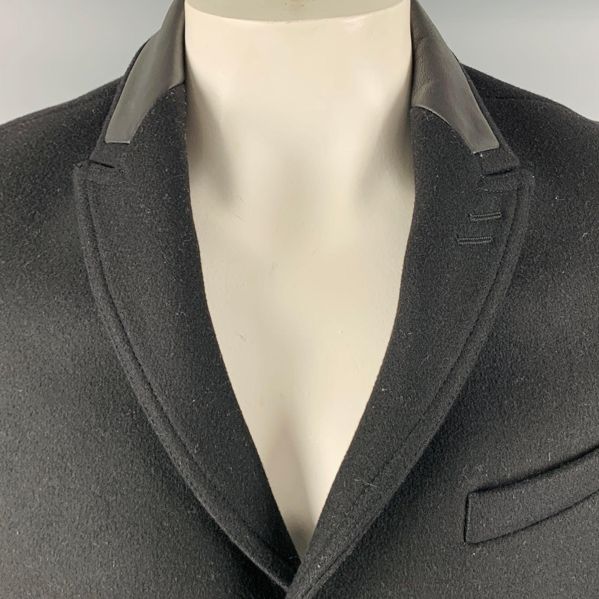 THE KOOPLES coat
in a black wool blend fabric featuring peak lapel with lambskin collar, two flap pockets, and button closure. Made in Romania.Excellent Pre-Owned Condition. 

Marked:   44 

Measurements: 
 
Shoulder: 16.5 inches Chest: 44 inches