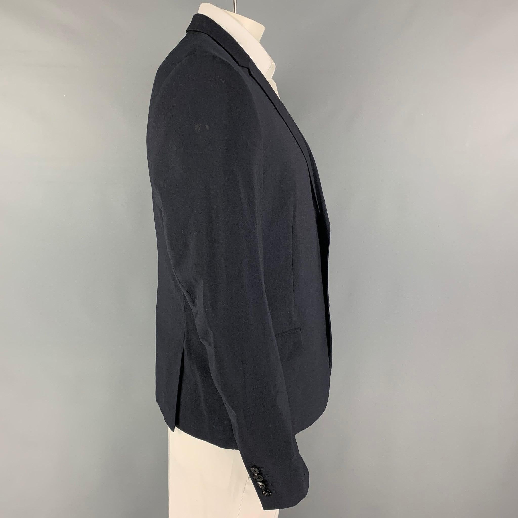 THE KOOPLES
sport coat comes in a navy wool with a full liner featuring a notch lapel, flap pockets, double back vent, and a double button closure. Excellent
Pre-Owned Condition. 

Marked:   54 

Measurements: 
 
Shoulder: 18.5 inches Chest: 44