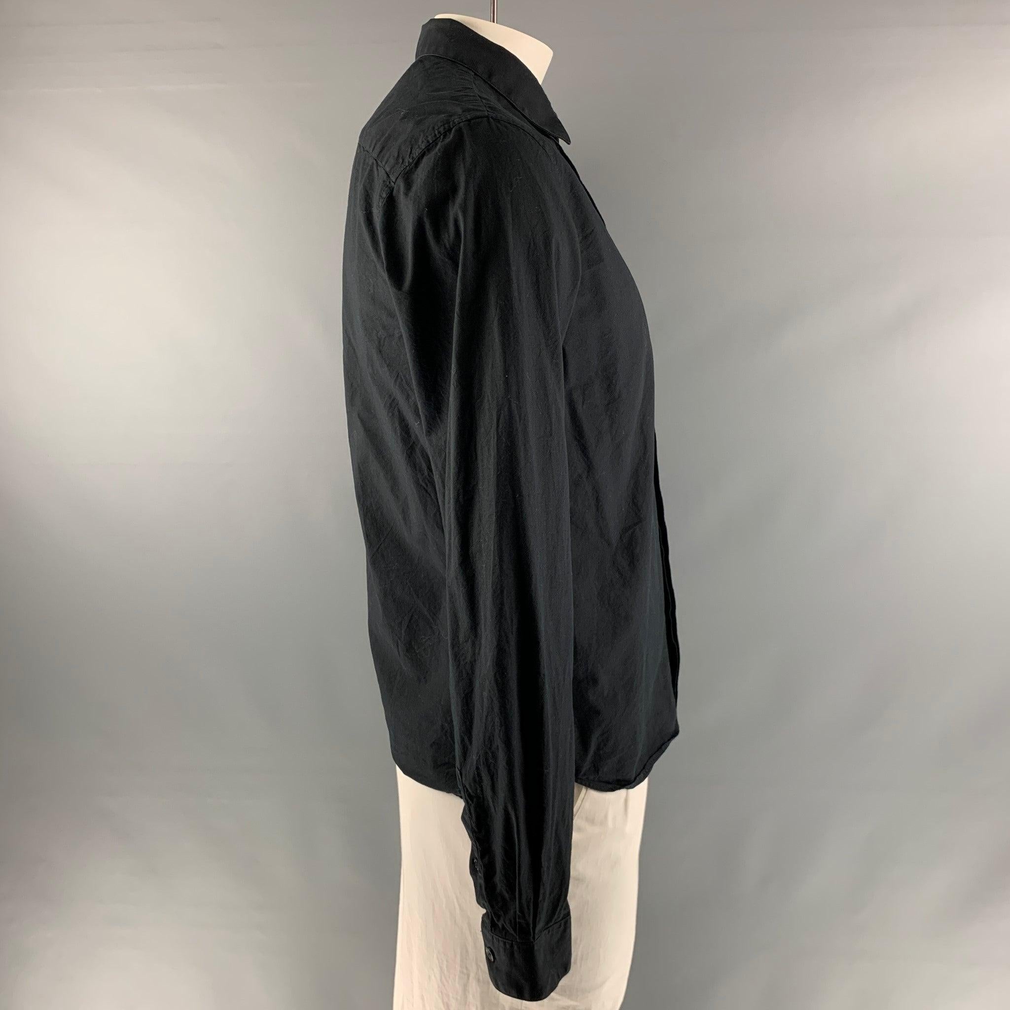 THE KOOPLES long sleeve shirt comes in a black cotton , featuring a slim fit, straight collar, and a hidden placket closure.Very Good Pre-Owned Condition. 

Marked:   L 

Measurements: 
 
Shoulder: 19 inches Chest: 42 inches Sleeve: 25 inches