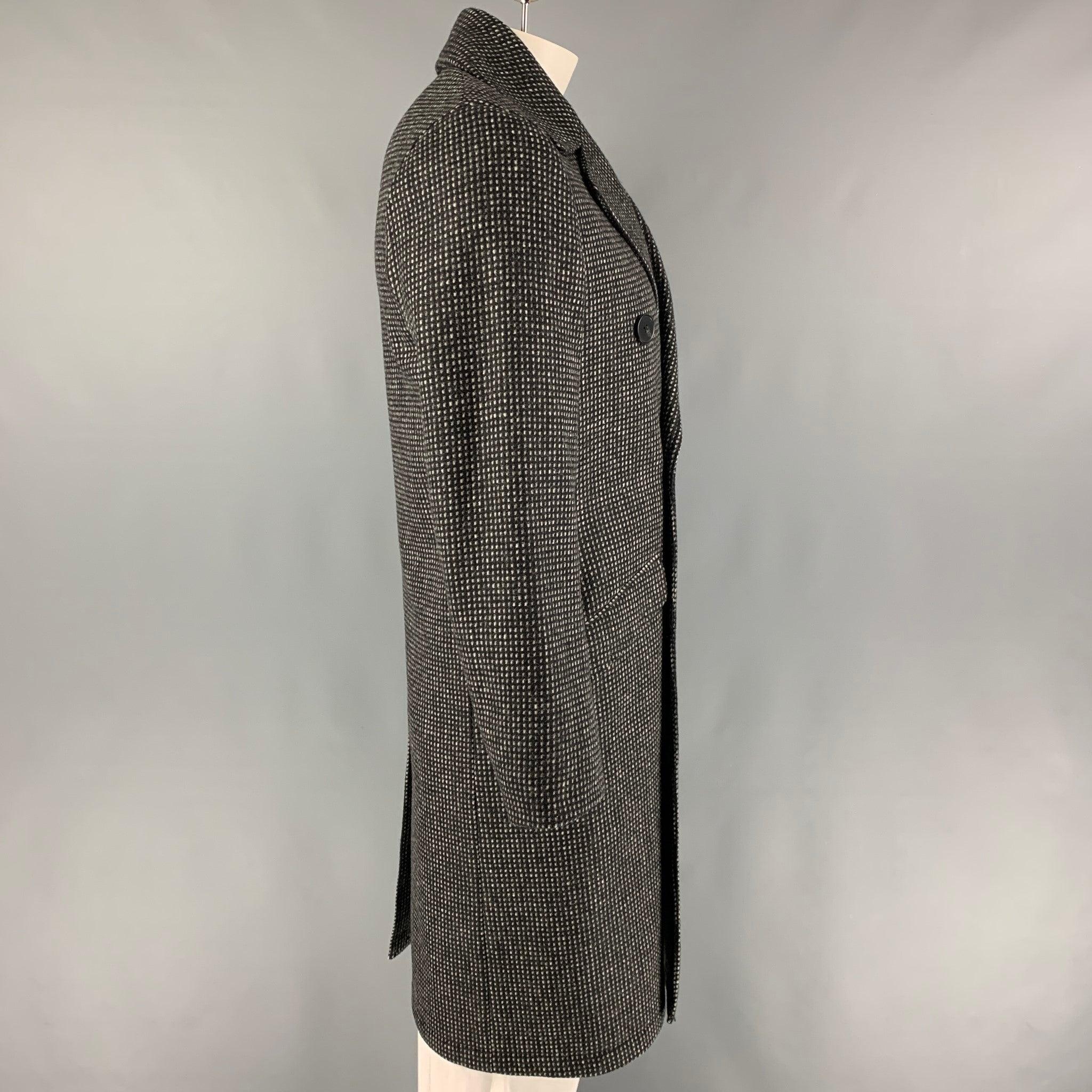 THE KOOPLES coat comes in a black & grey grid wool blend featuring a notch lapel, flap pockets, single back vent, and a double breasted closure.
Very Good
Pre-Owned Condition. 

Marked:   48 R 

Measurements: 
 
Shoulder: 17.5 inches  Chest: 42