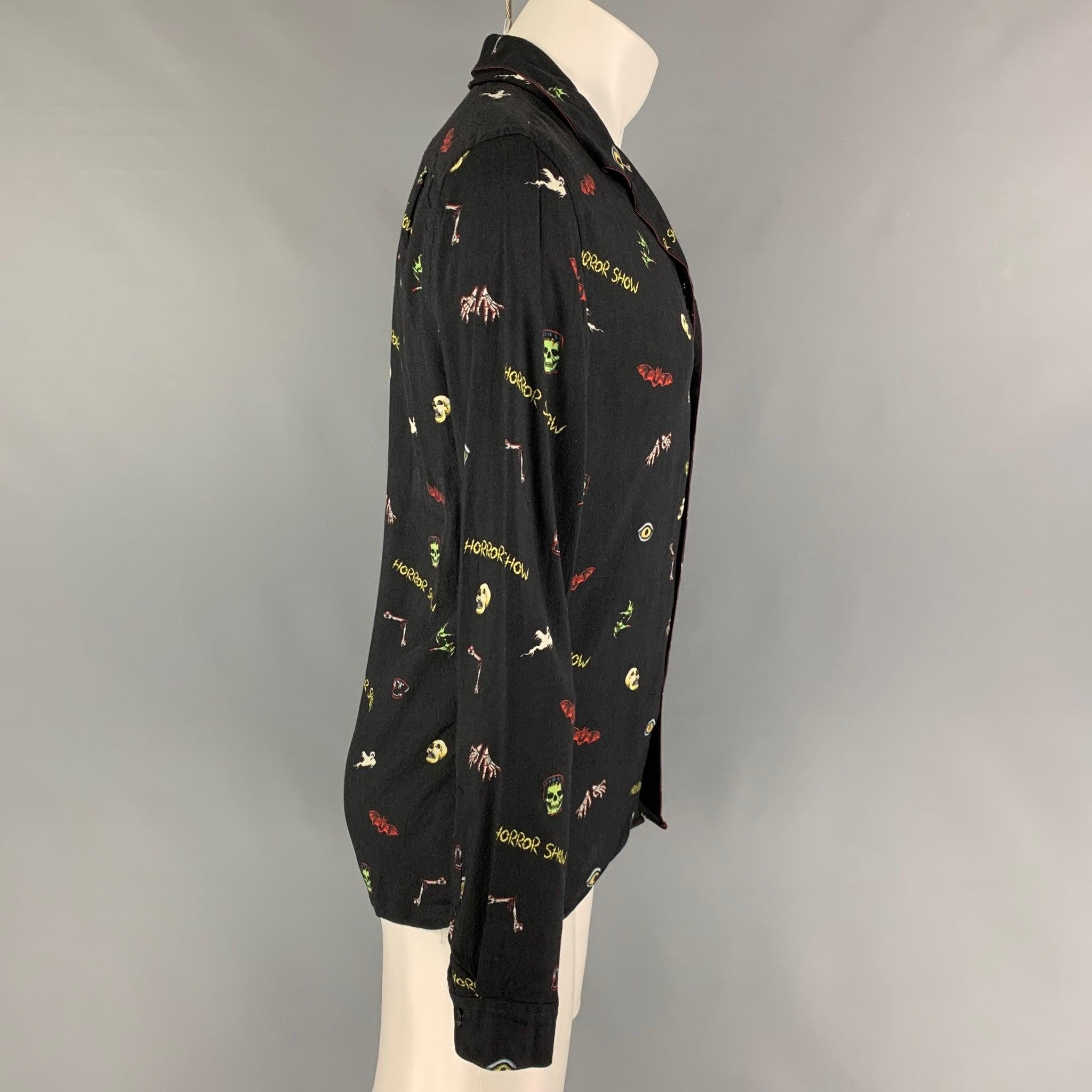 THE KOOPLES long sleeve shirt comes in a black viscose with a multi-color graphic design featuring a camp collar and a button up closure.
Very Good
Pre-Owned Condition. 

Marked:   S 

Measurements: 
 
Shoulder: 17 inches  Chest: 38 inches  Sleeve: