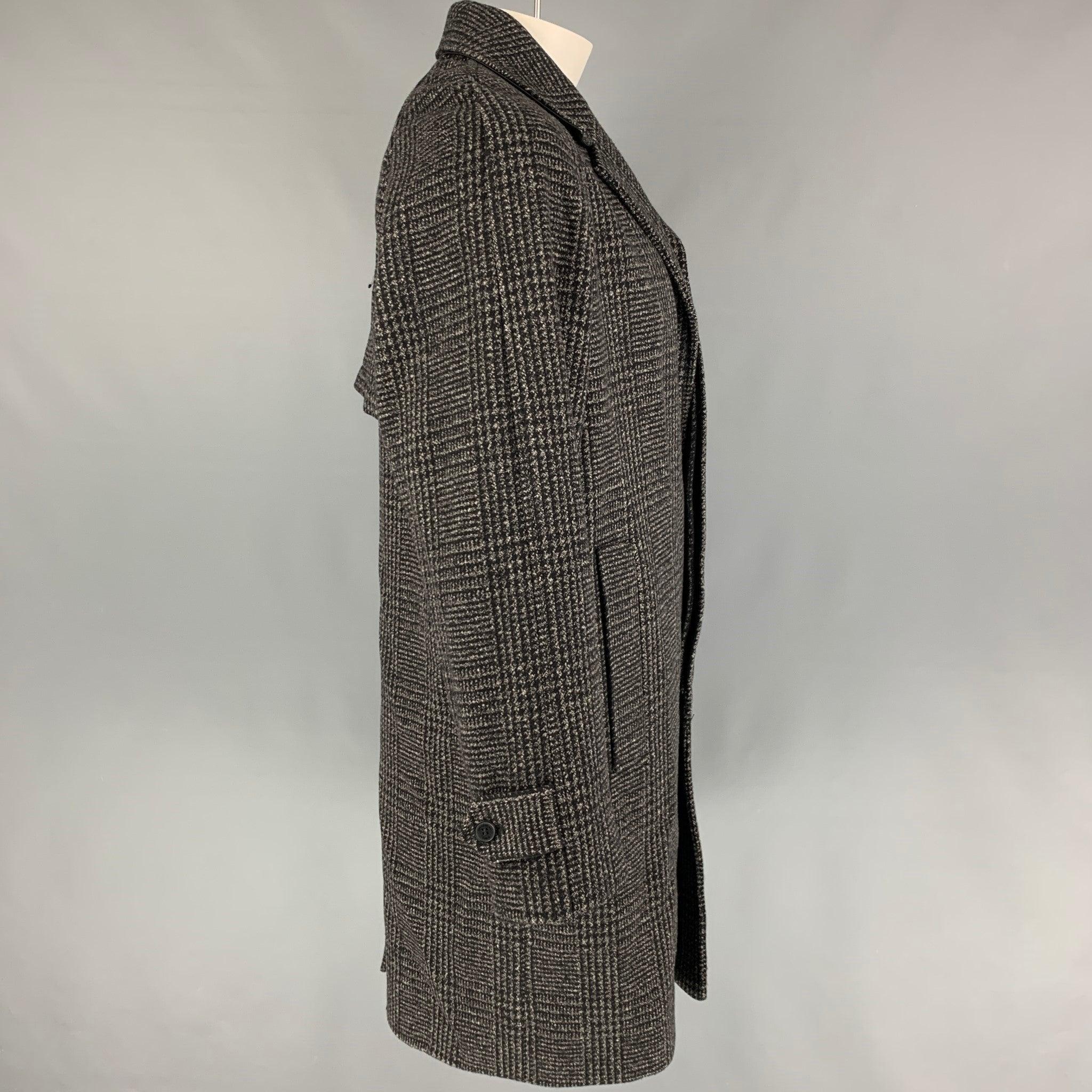 THE KOOPLES coat comes in a grey & black plaid wool featuring a notch lapel, slit pockets, single back vent, and a hidden placket closure.
Very Good
Pre-Owned Condition. 

Marked:   XL  

Measurements: 
 
Shoulder: 18.5 inches Chest: 49 inches