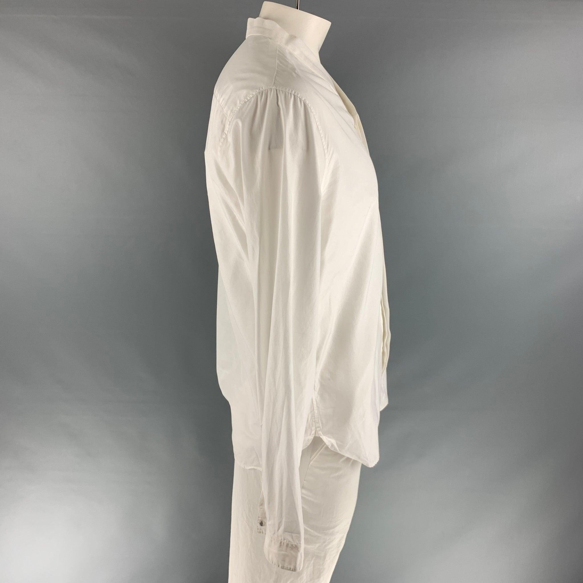 THE KOOPLES long sleeve shirt comes in a white cotton featuring a slim fit, open deep collar, and hidden placket. Made in Italy.Very Good Pre-Owned Condition. 

Marked:   XL 

Measurements: 
 
Shoulder: 20 inches Chest: 40 inches Sleeve: 26 inches
