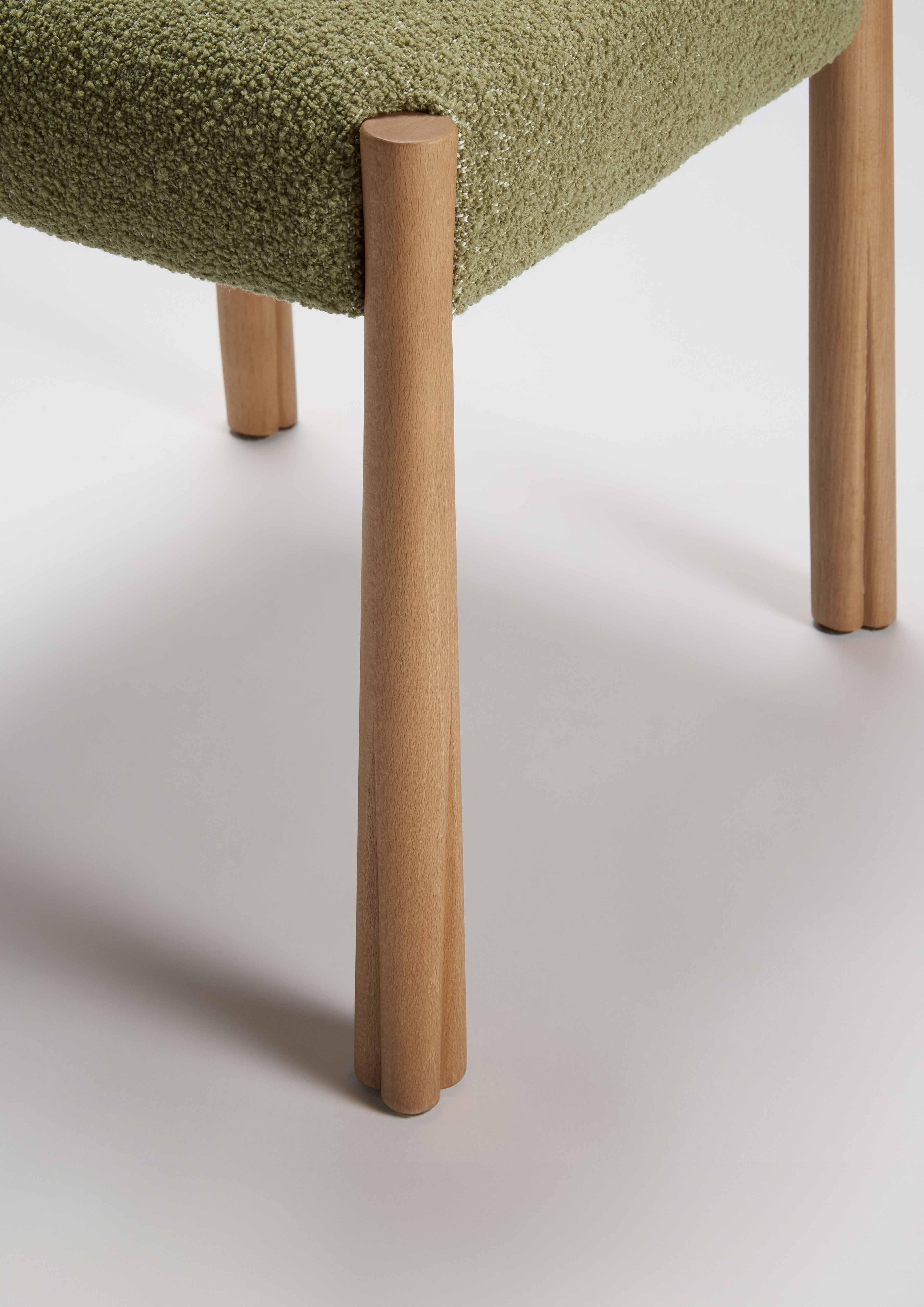 The Kudu Dining Chair borrows its poise and geometry from the king of antelopes. The legs are shaped from solid beech, then finished with a rustic oil and unique detailed carving at the feet, mimicking the hooves of this gracious beast. Upholstered
