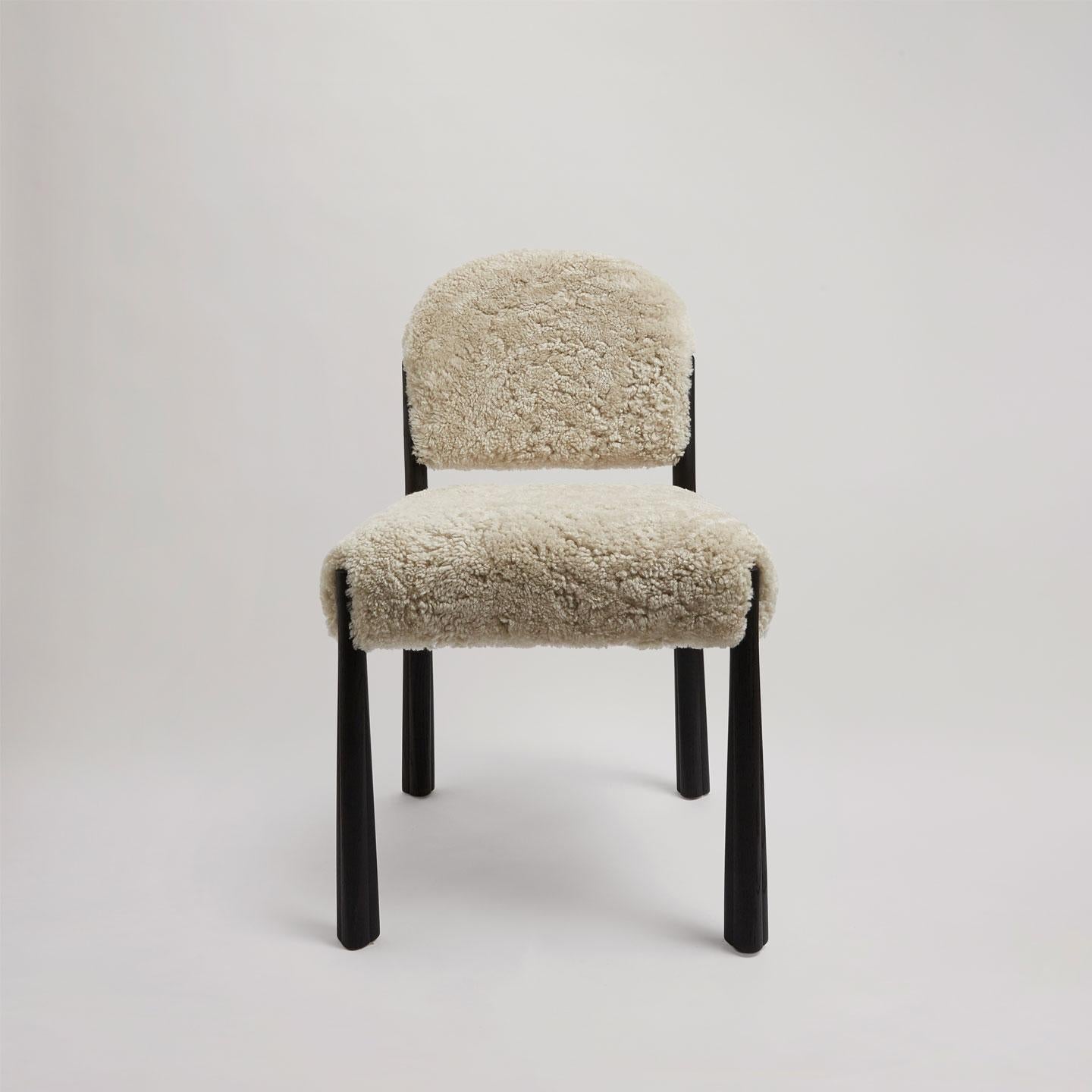 The Kudu Dining Chair draws its elegant poise and geometry from the majestic king of antelopes. Crafted from solid oak with a black stain, the legs are shaped with precision and finished with rustic oil. The feet feature unique detailed carvings