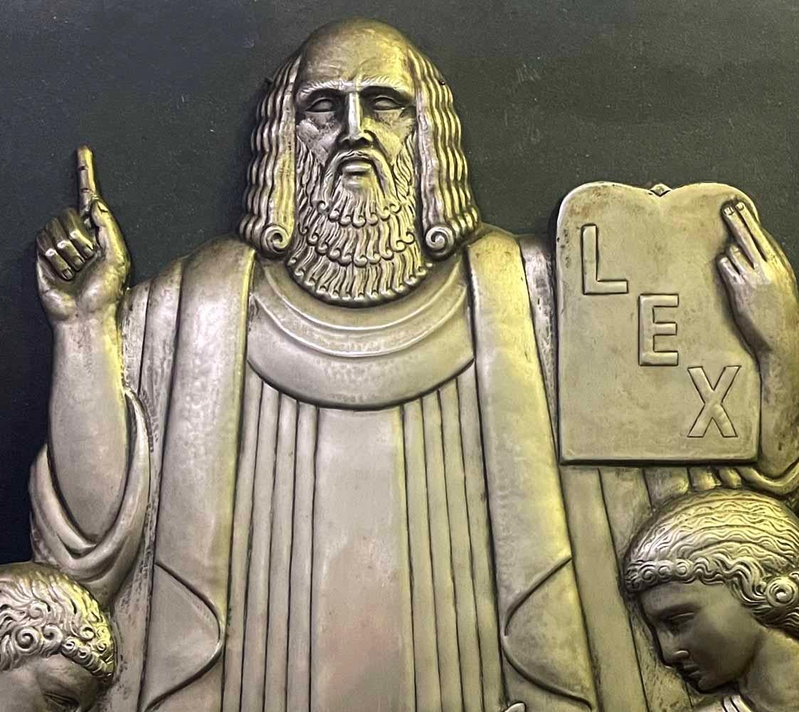 An exceptional example of high style Art Deco architectural sculpture, this relief panel depicts Moses holding a tablet emblazoned with 