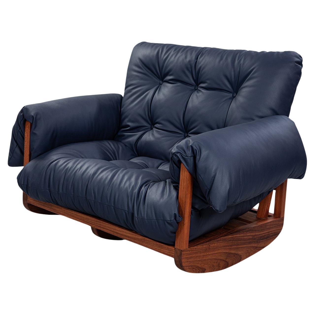 Laziness is a laid-back and spacious rocking armchair, crafted for sitting/lying down and unwinding. The low seat height from the ground draws inspiration from Japanese rocking chairs, while the wooden structure is strongly influenced by Brazilian