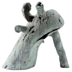 The leaning outcast, contemporary sculpure in cast bronze, white-green patina
