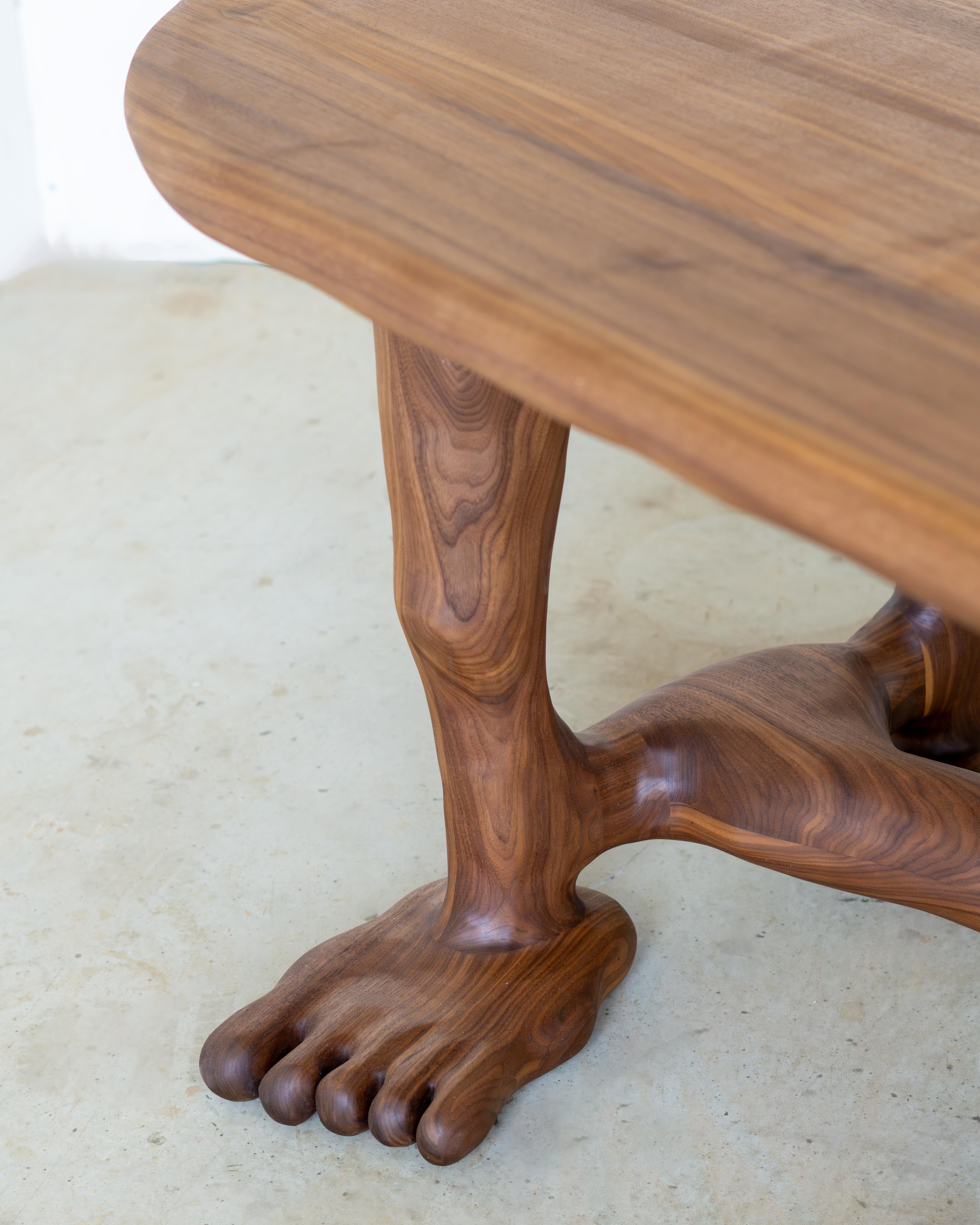 The Leg Dining Table is sculpted using various hand tools, making each piece unique with its own distinctive wood grain. The sculptural table is characterized by its seamless flow, with no sharp edges or corners.  It is crafted from a large piece of