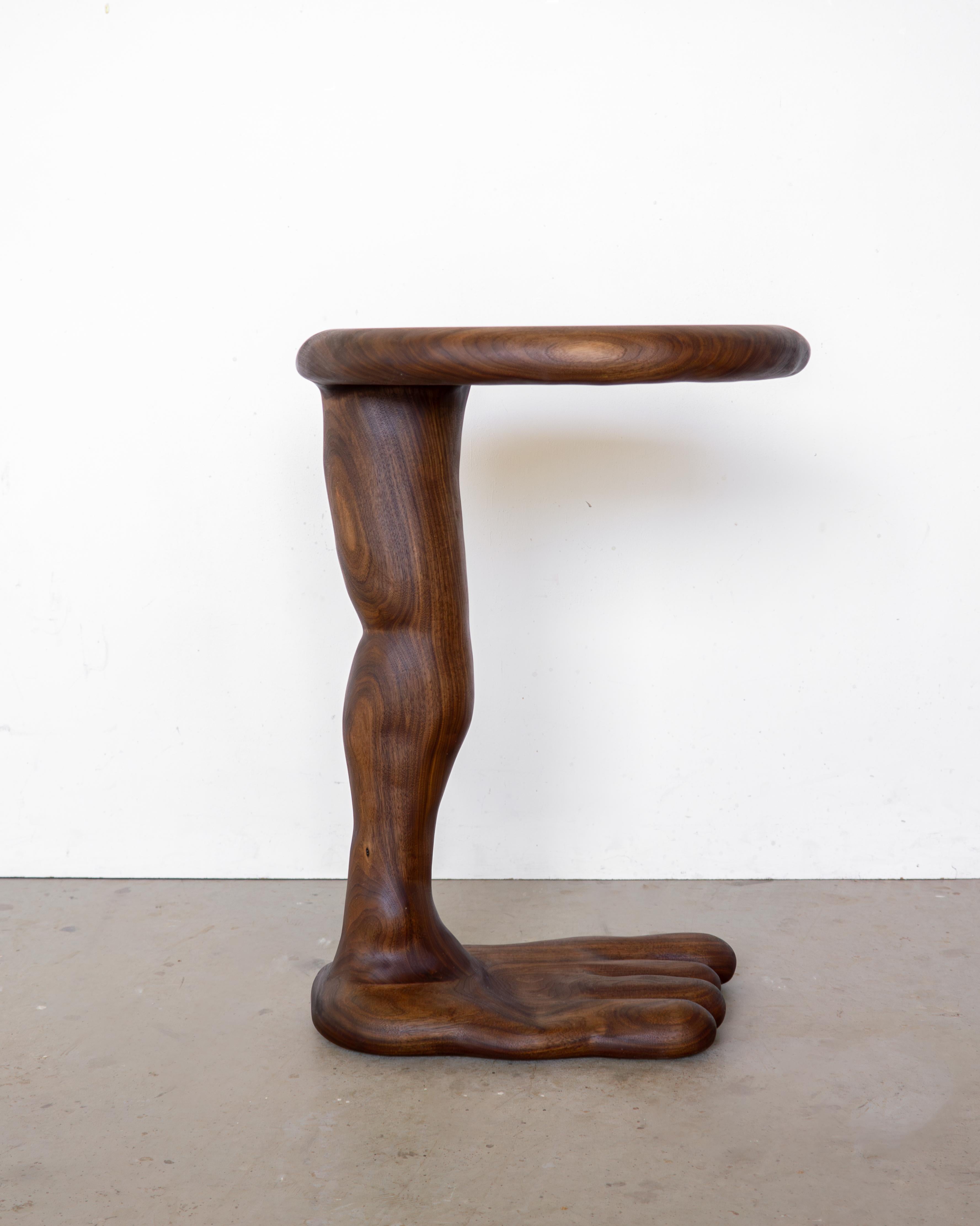 The Leg Side Table is sculpted using various hand tools, making each piece unique with its own distinctive wood grain. 

It is made from high-quality walnut wood and finished with a natural hardwax oil, providing protection to the wood in daily use