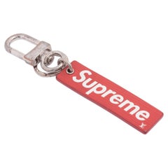 The Louis Vuitton X Supreme Keychain features Louis Vuitton’s red signature 