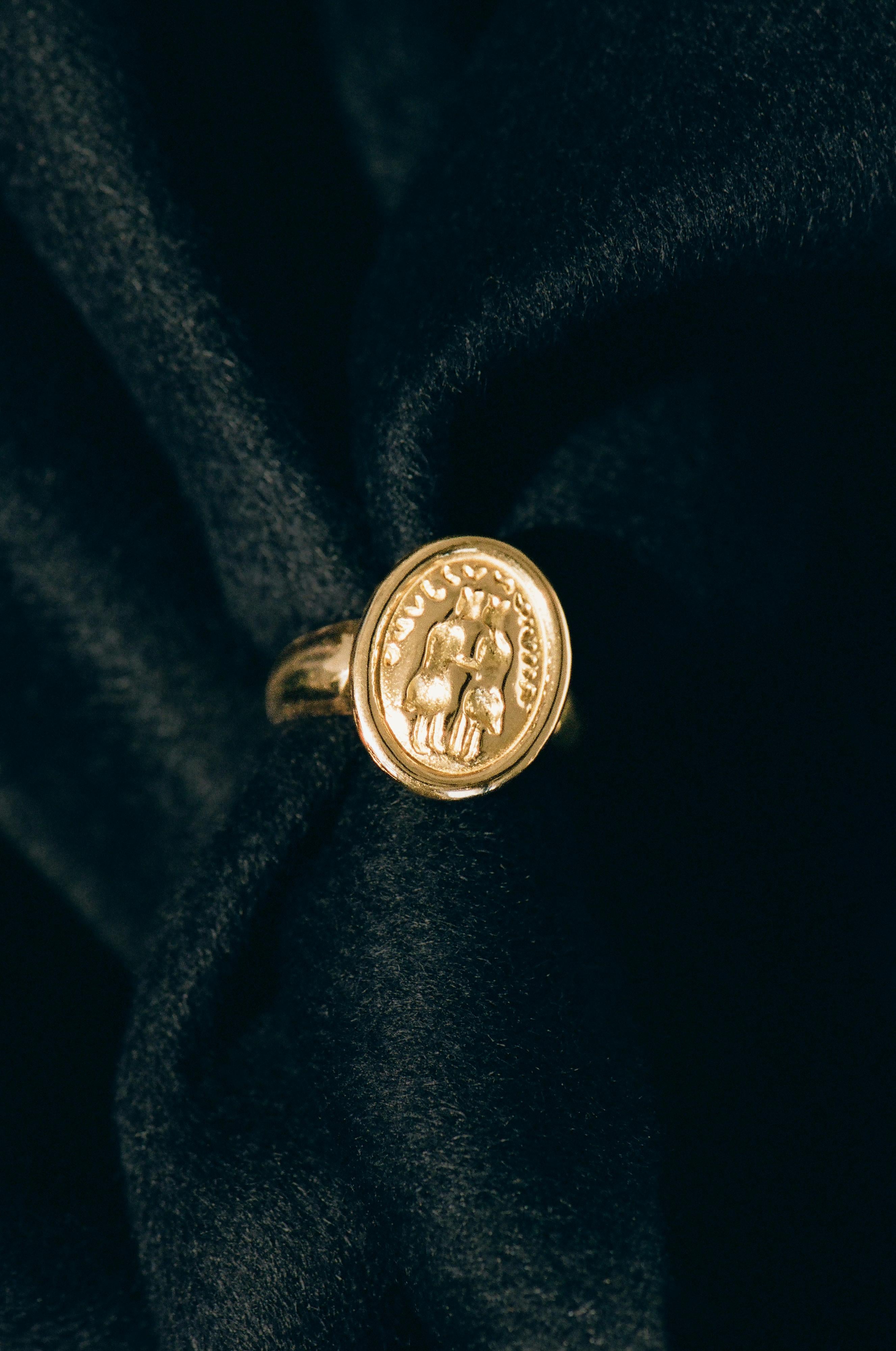 A one-of-a-kind signet ring featuring a reverse hand-carved motif depicting a duo of lovers. At once refined and pleasingly weighty, this refined ring is crafted from 18k recycled gold and detailed with a reverse, signet-style hand-carving from an