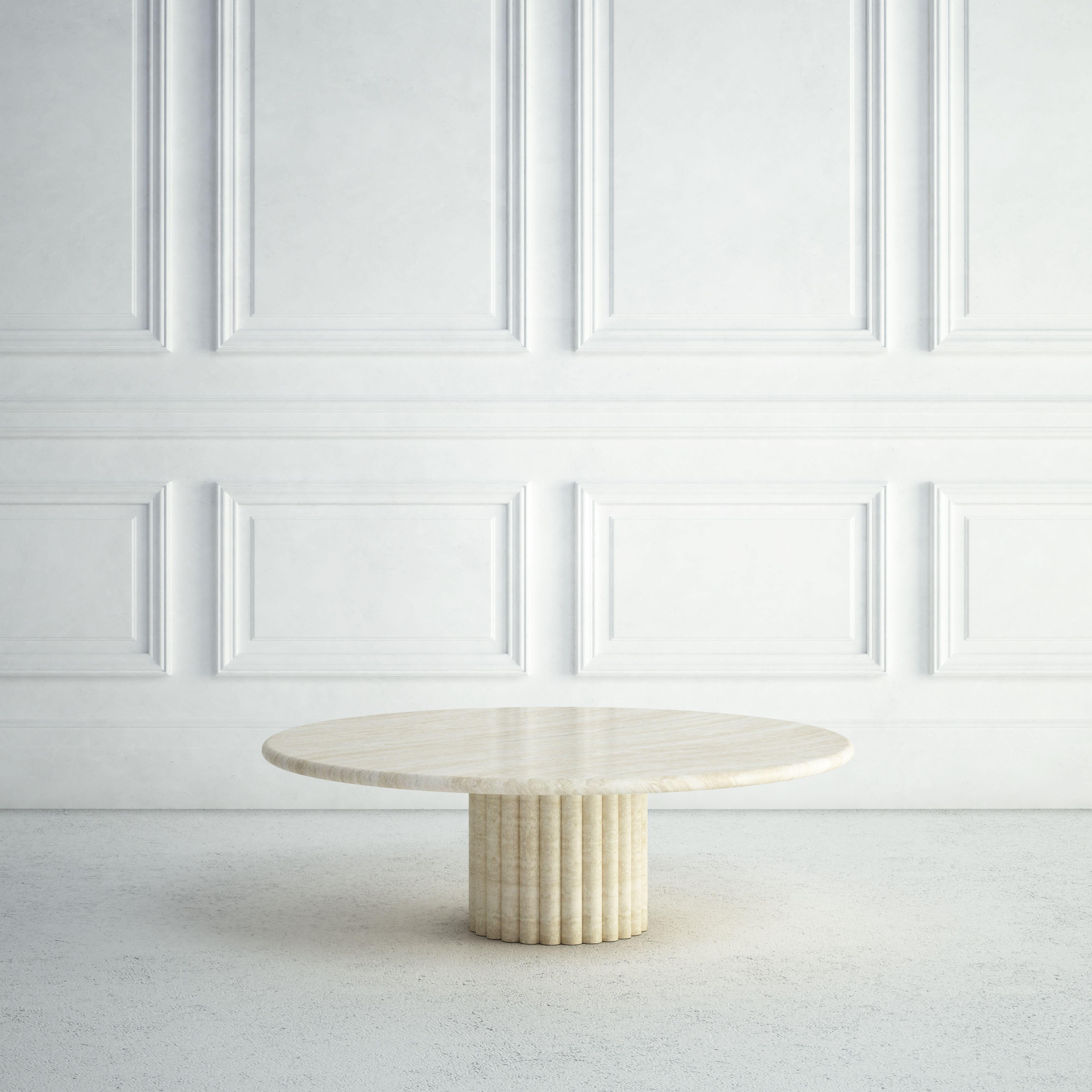 The Lucie is a modern stone coffee table, with a generous round top, and a bullnose edge detail.  The short rounded base is artfully made from several bullnose vertical sections.  All of these elements give it a distinctively stylish but softer