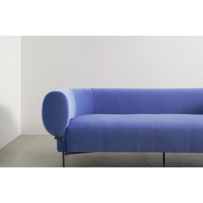 The Madda by Michael Felix is a contemporary, modern, and minimal velvet sofa inspired by the interpretation of classic mid-century club chairs. Its metal base wraps around the plump cushion as if to squeeze the seat full of support and comfort.
