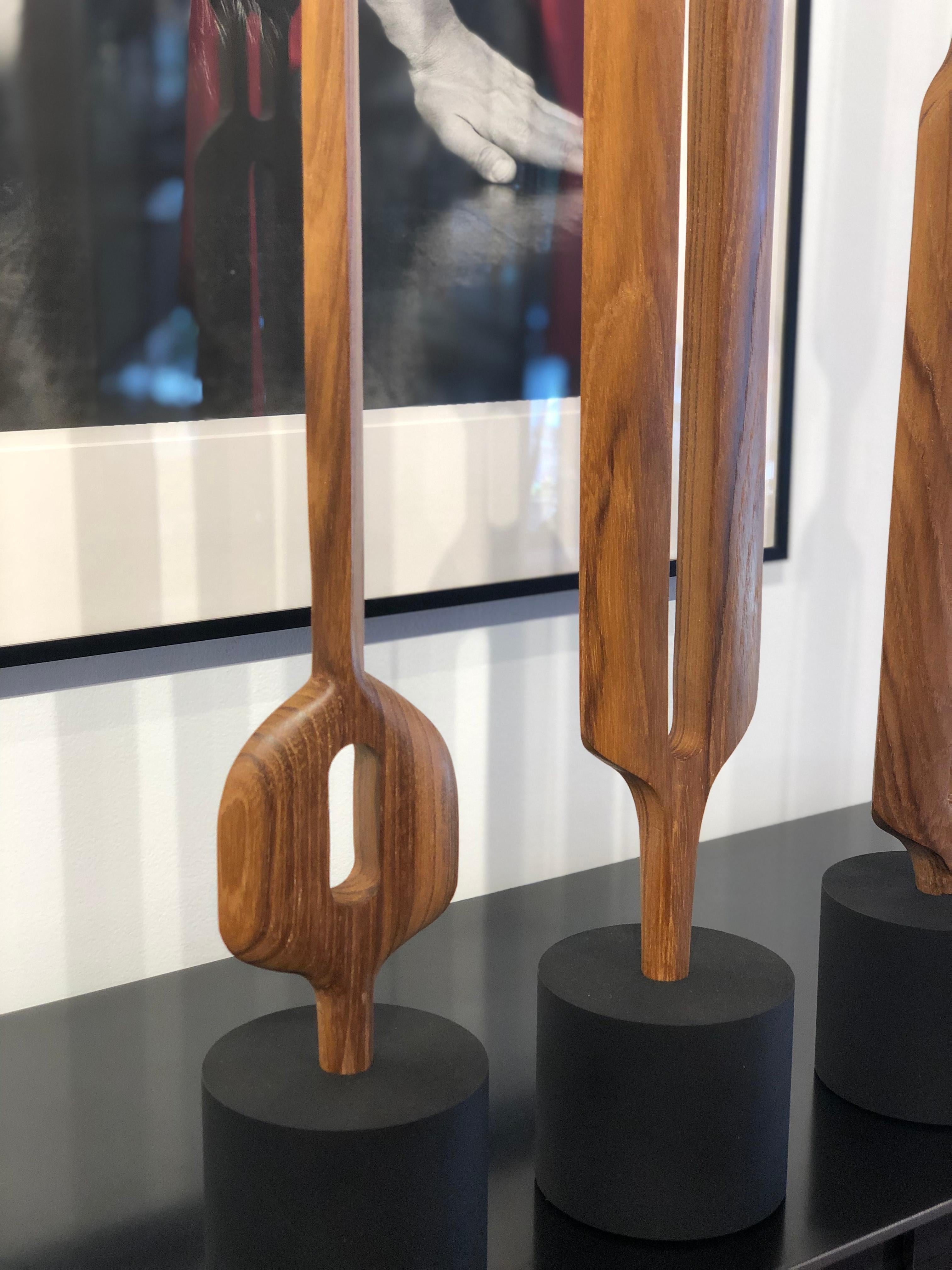 Teak is a dense tropical hardwood with a gray to brown color and finely textured with a tight grain and smooth surface when polished. These hand carved and shaped totem sculptures bring out the natural beauty of the wood's graceful structure. Each