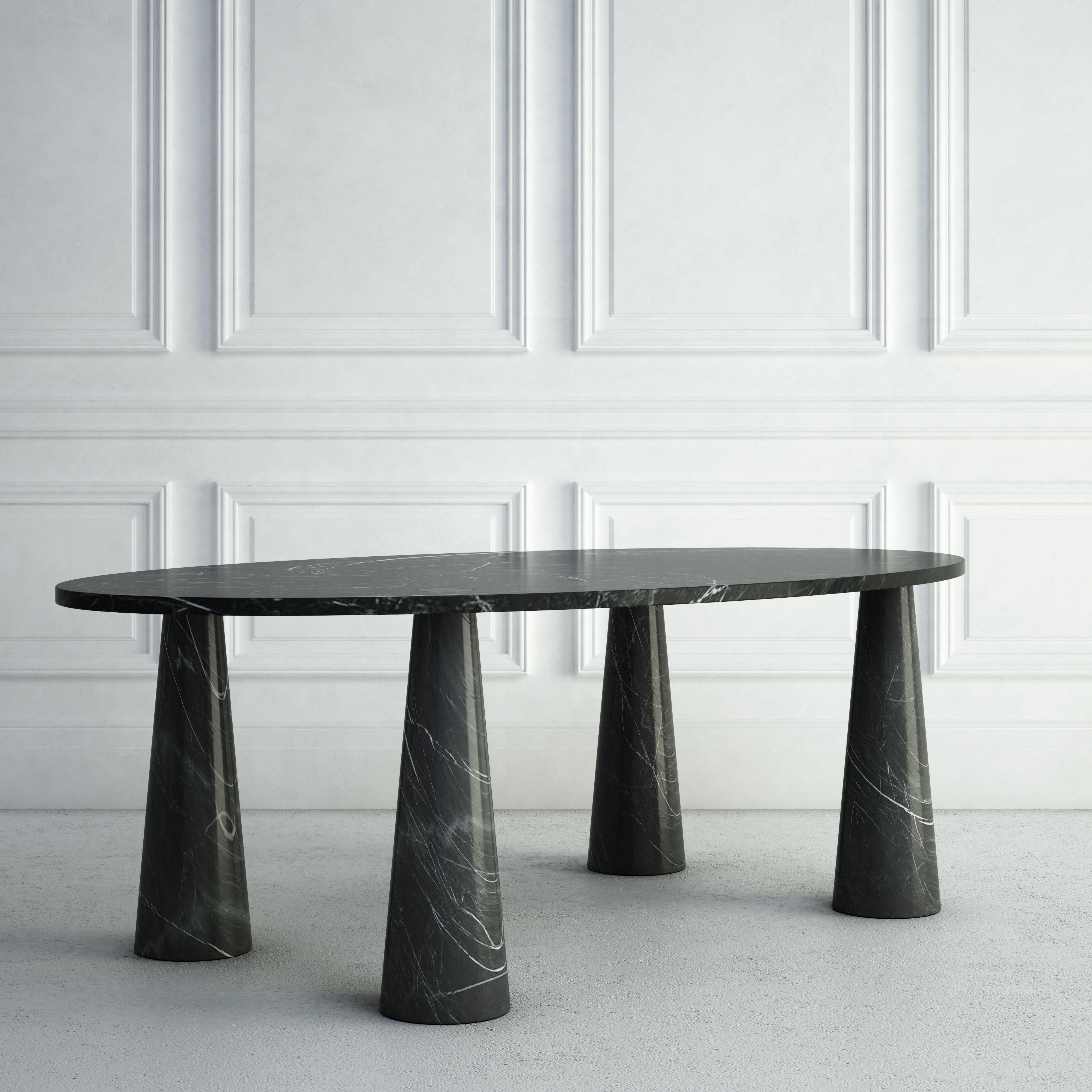 The Marianne is a whimsical modern dining table, and a variation of our Simone Table.  The top is made from an elegant thin oval stone slab.  The legs are rounded, but taper in as they reach the top, giving them a conical shape.  The