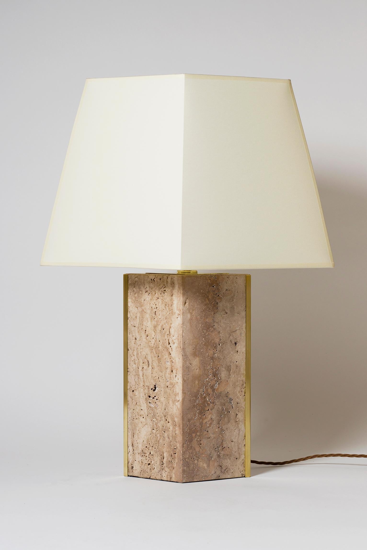 The 'Marine' table lamp, by Dorian Caffot de Fawes.
Limited Edition of 12 singles lamps. 
Solid Italian quarried travertine, with brass mounts and bespoke diamond shaped shades (made in the UK)
With the shade: 67 cm high by 49 cm wide by 27 cm