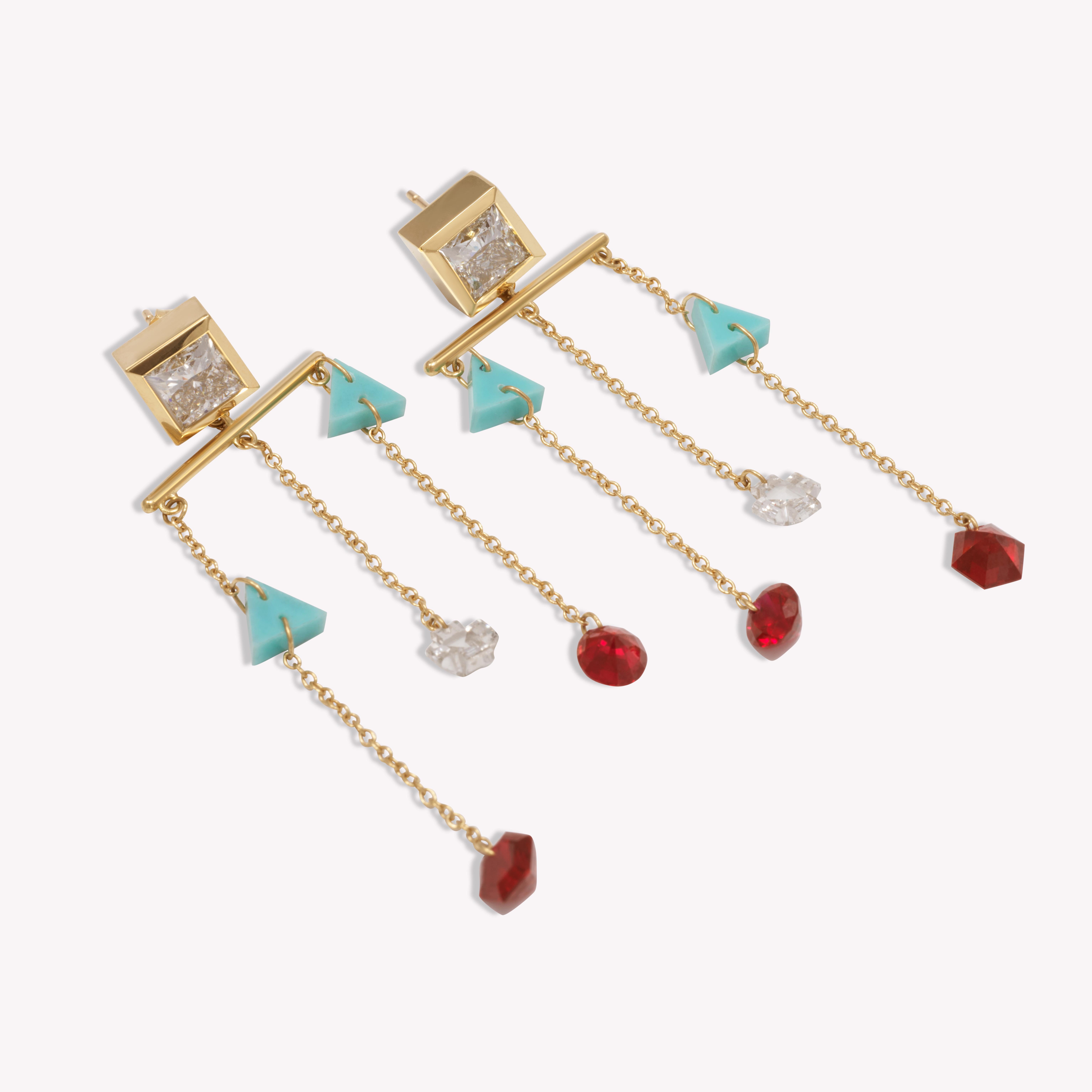 The Marionettes draw inspiration from the art deco era in both color and style. Embodying a stained glass effect, these drop down earrings are set with approximately 3cts of diamonds: a mixture of princess cut diamond studs and custom cut cross