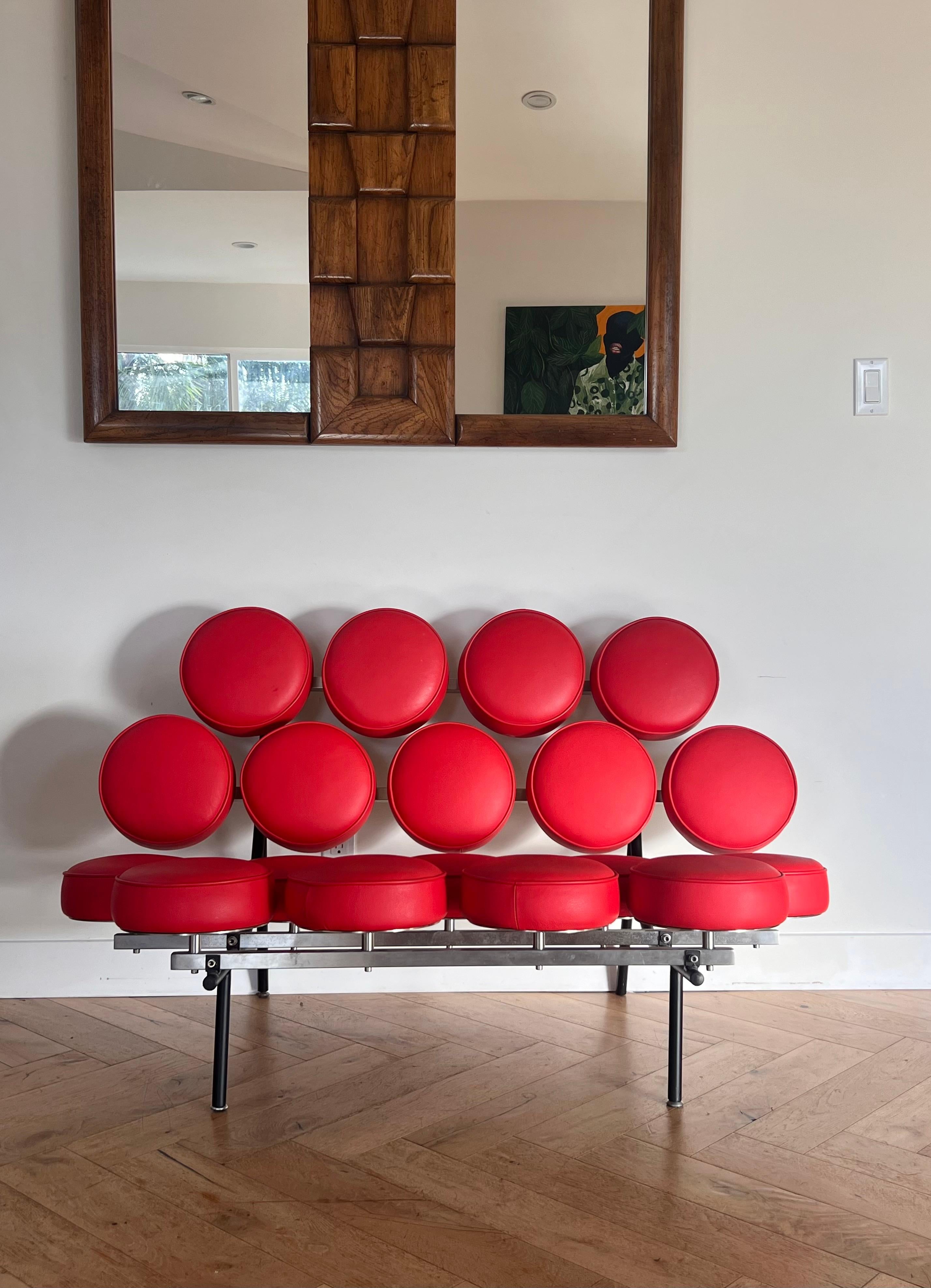 The Marshmallow loveseat by George Nelson for Herman Miller, late 20th century reproduction. Designed 1956. Two-seater with metal frame mounted with leather-wrapped and cushioned wood pads in Ferrari red. Pick up in central west Los Angeles or we